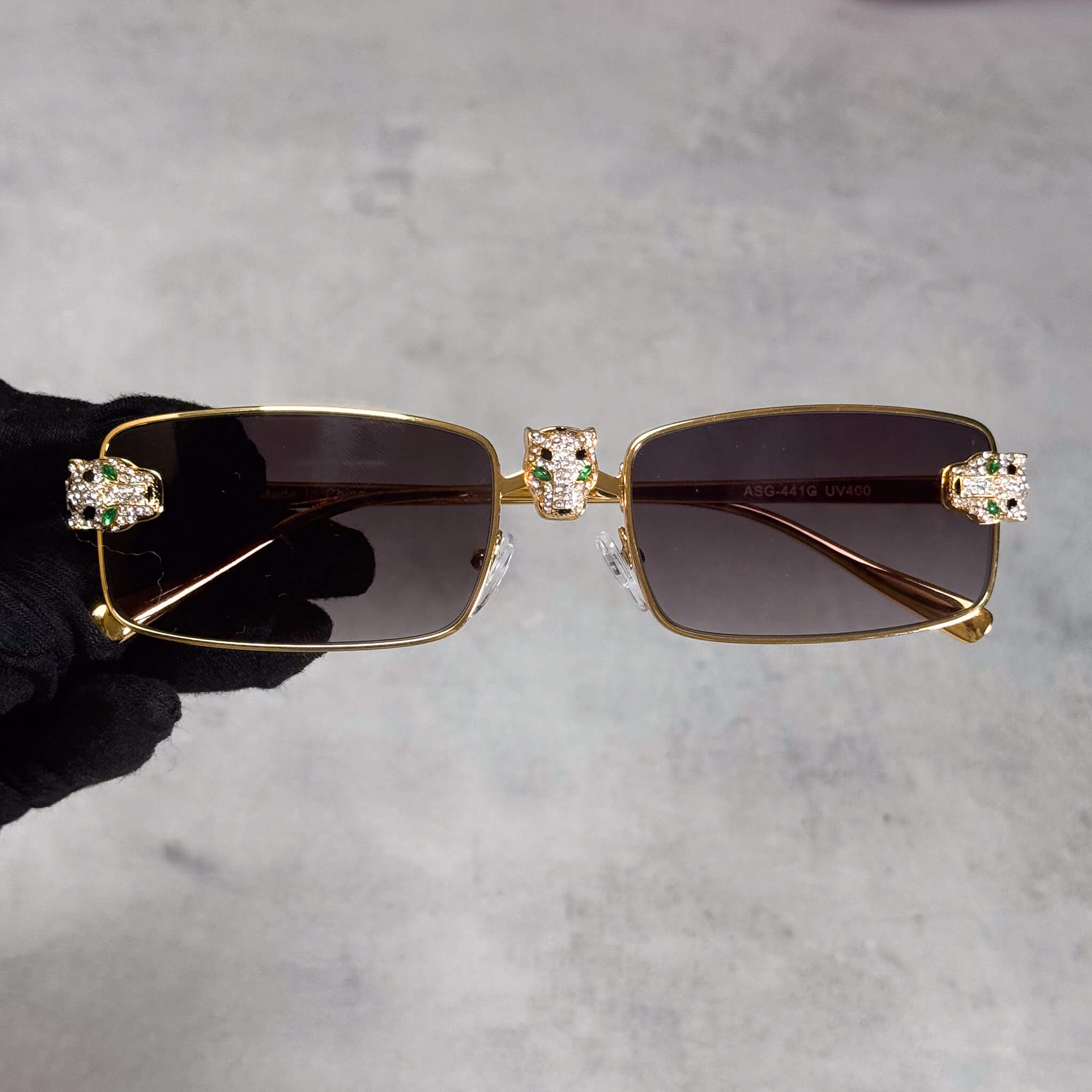 Gold Iced Out Panther Sunglasses with smoke rectangular lenses and jeweled panther accents.