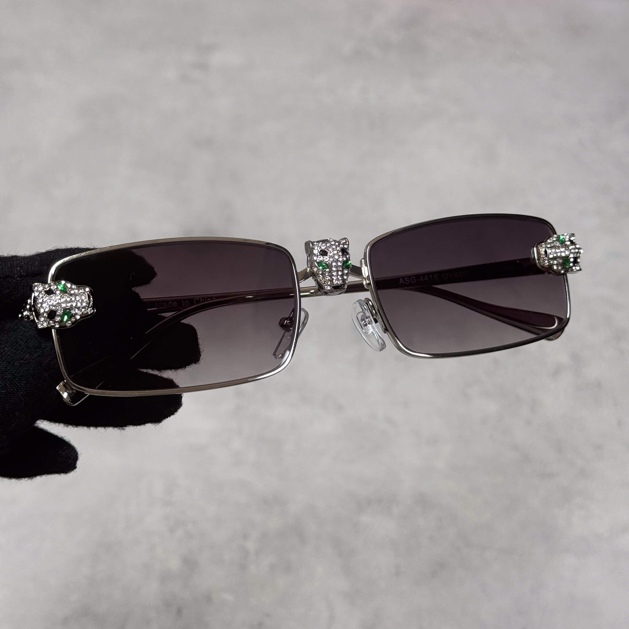 Silver Iced Out Panther Sunglasses with smoke rectangular lenses and crystal panther details.