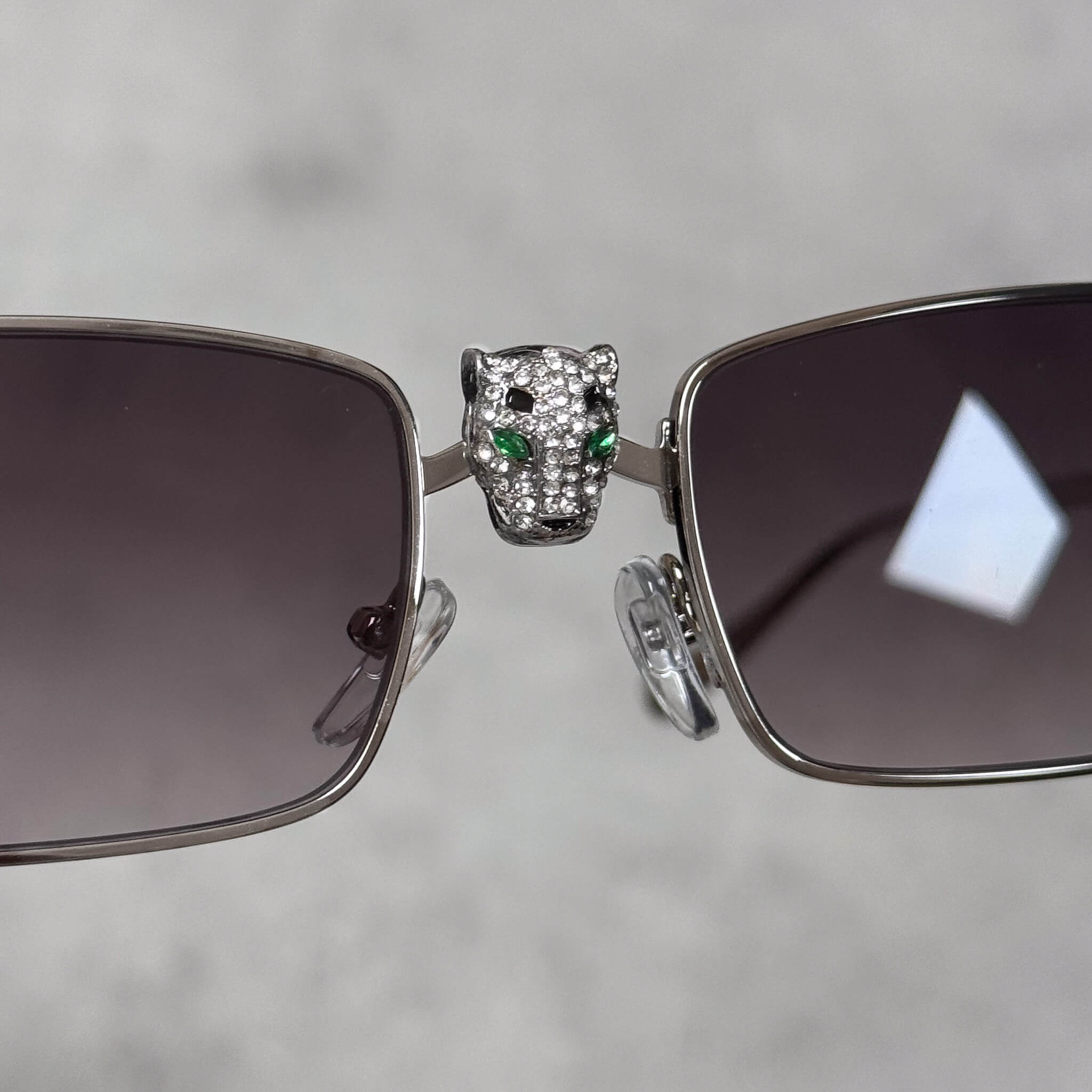Front view of silver Iced Out Panther Sunglasses featuring smoke lenses and panther centerpiece.
