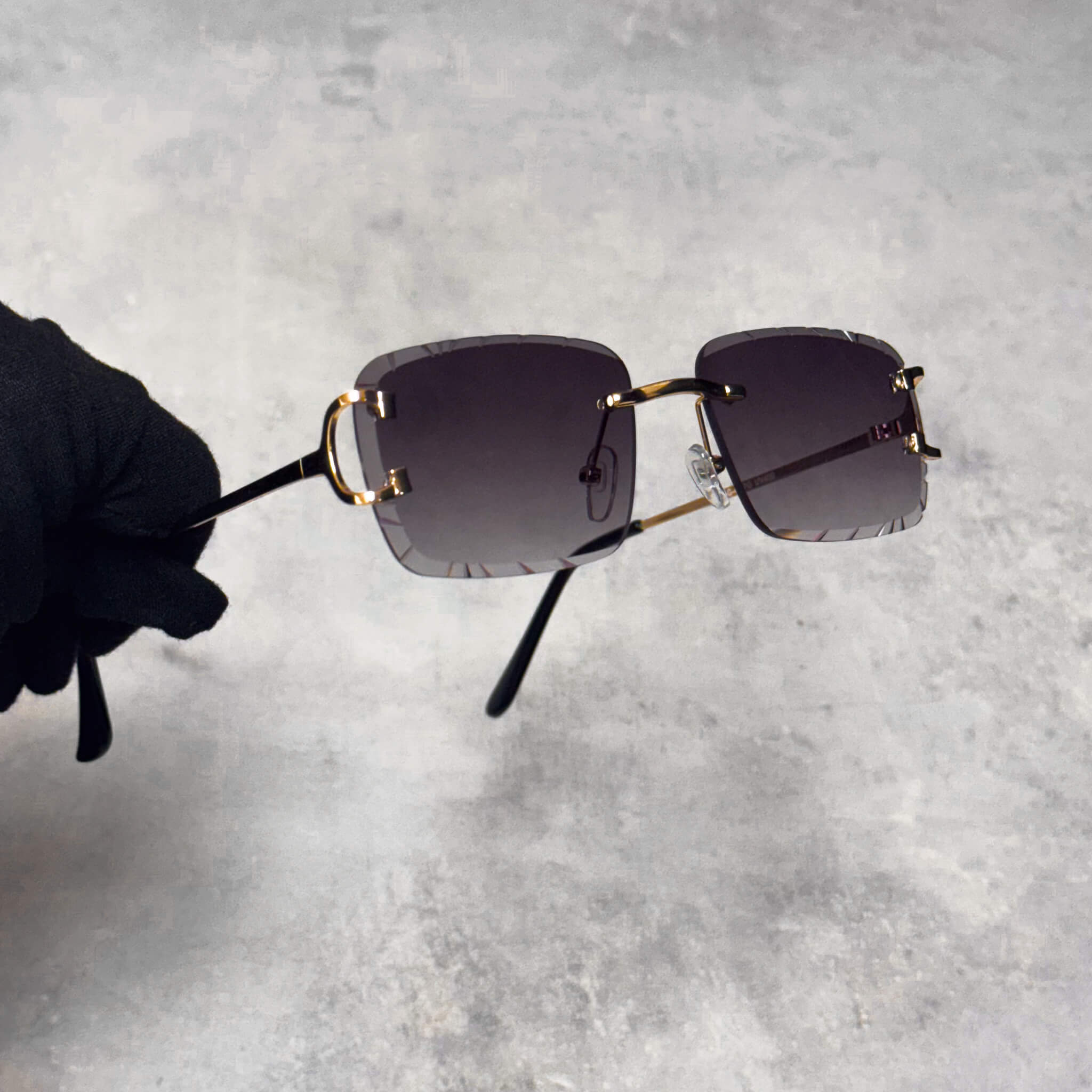 Side view of smoke cut-edge sunglasses with gold temples and squared gradient lenses.