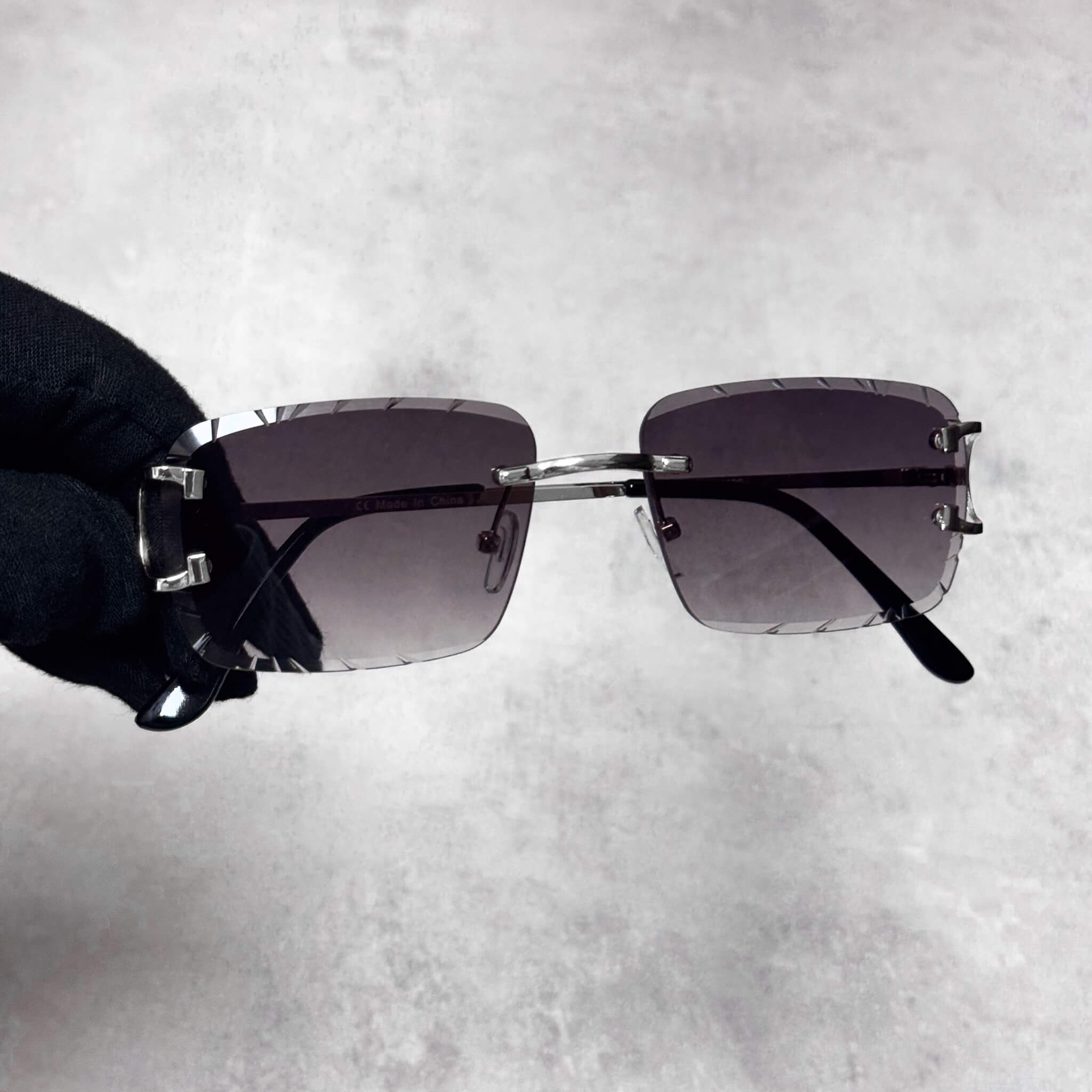 Smoke cut-edge sunglasses with silver bridge and square gradient lenses, modern luxury style.
