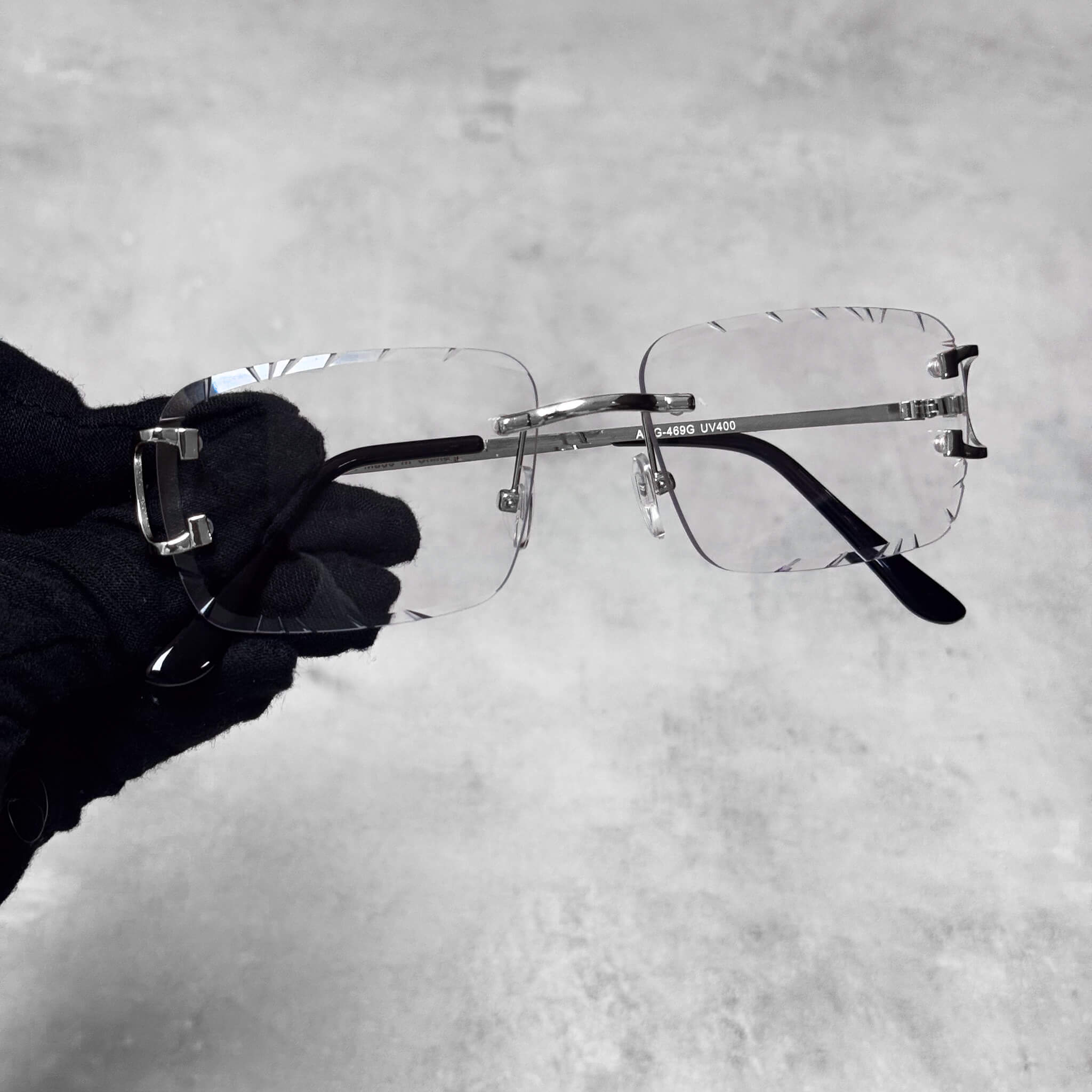 Solid Cut-Edge Sunglasses with clear square lenses and polished silver metal frame.