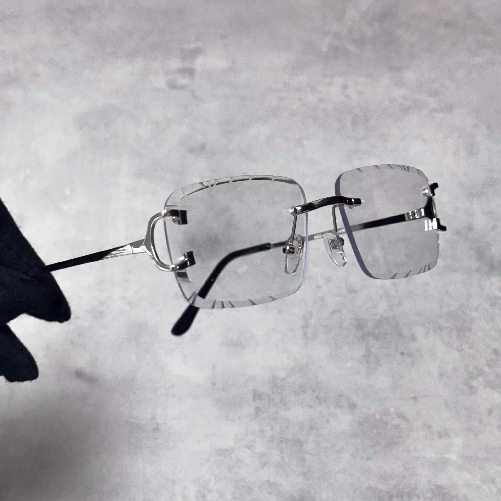 Rimless clear-lens Solid Cut-Edge Sunglasses with silver temples.