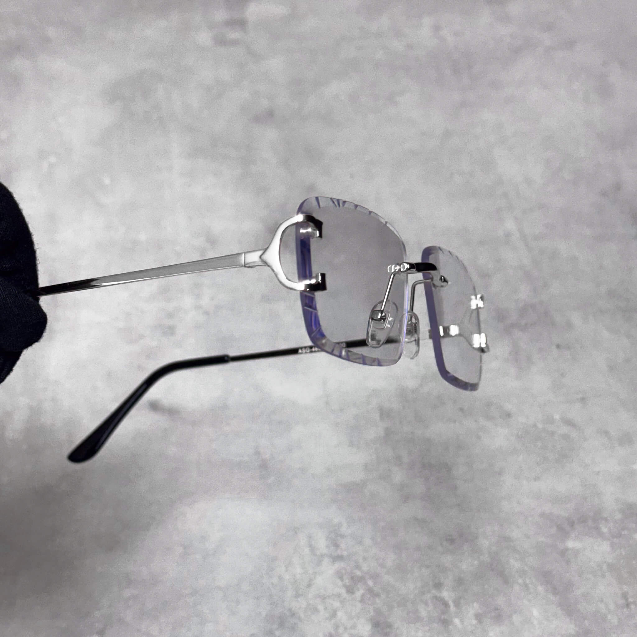 Side view of silver-frame Solid Cut-Edge Sunglasses featuring clear lenses and cut edges.