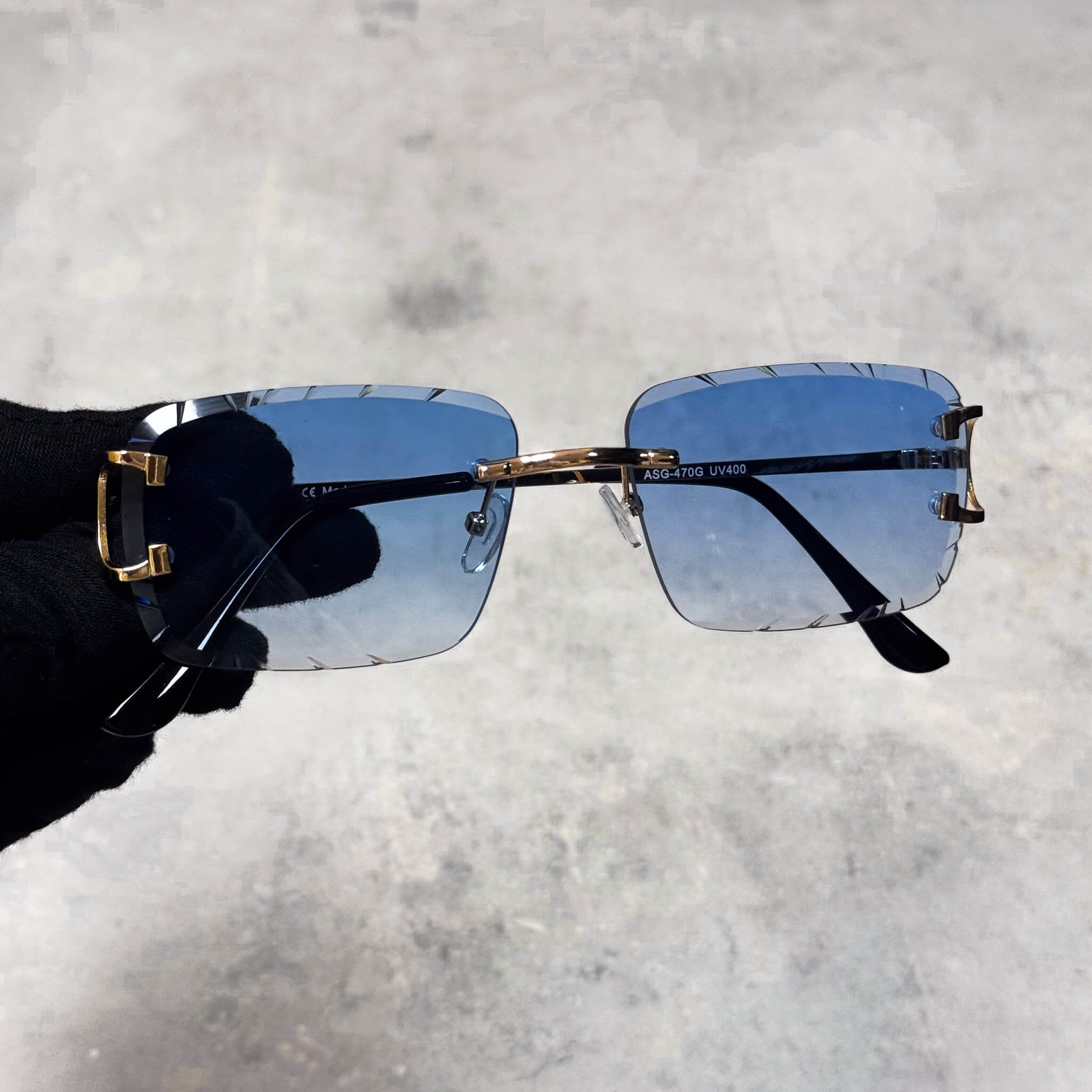 Blue-lens Solid Cut-Edge Sunglasses featuring rimless square shape and gold bridge detail.