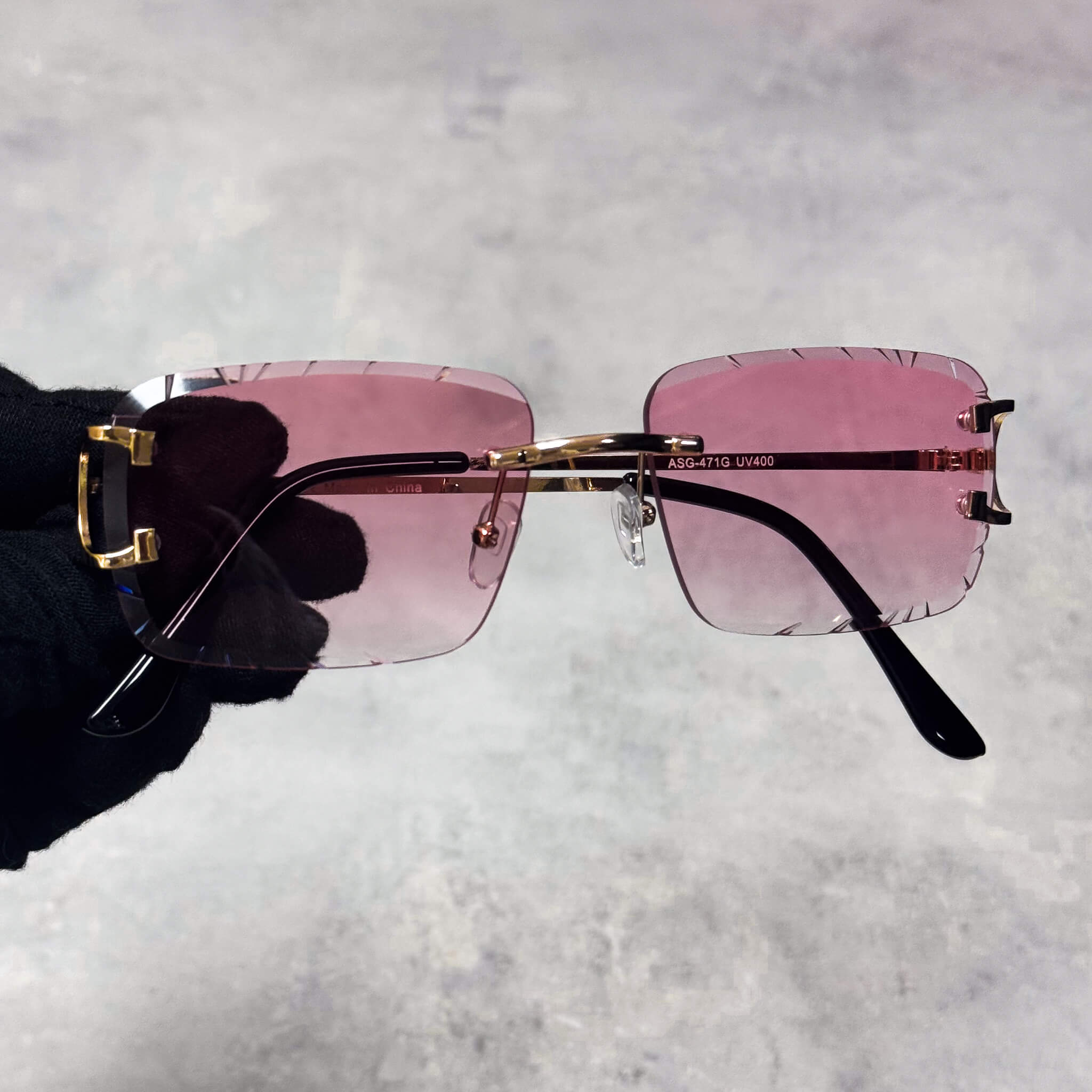 Pink Solid Cut-Edge Sunglasses with gold bridge, rimless square lenses.
