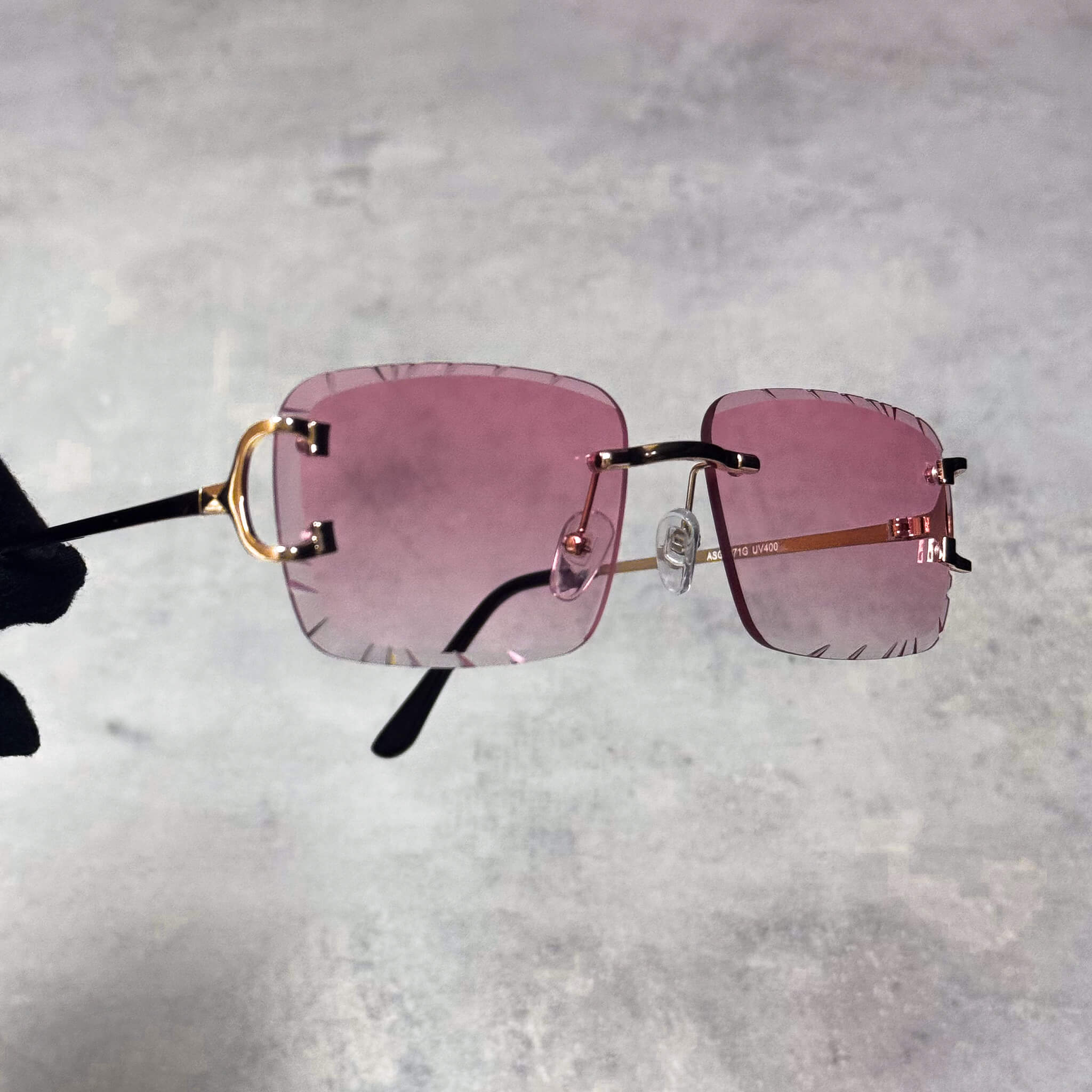 Rimless pink Solid Cut-Edge Sunglasses featuring gold temples and cut-edge square lenses.