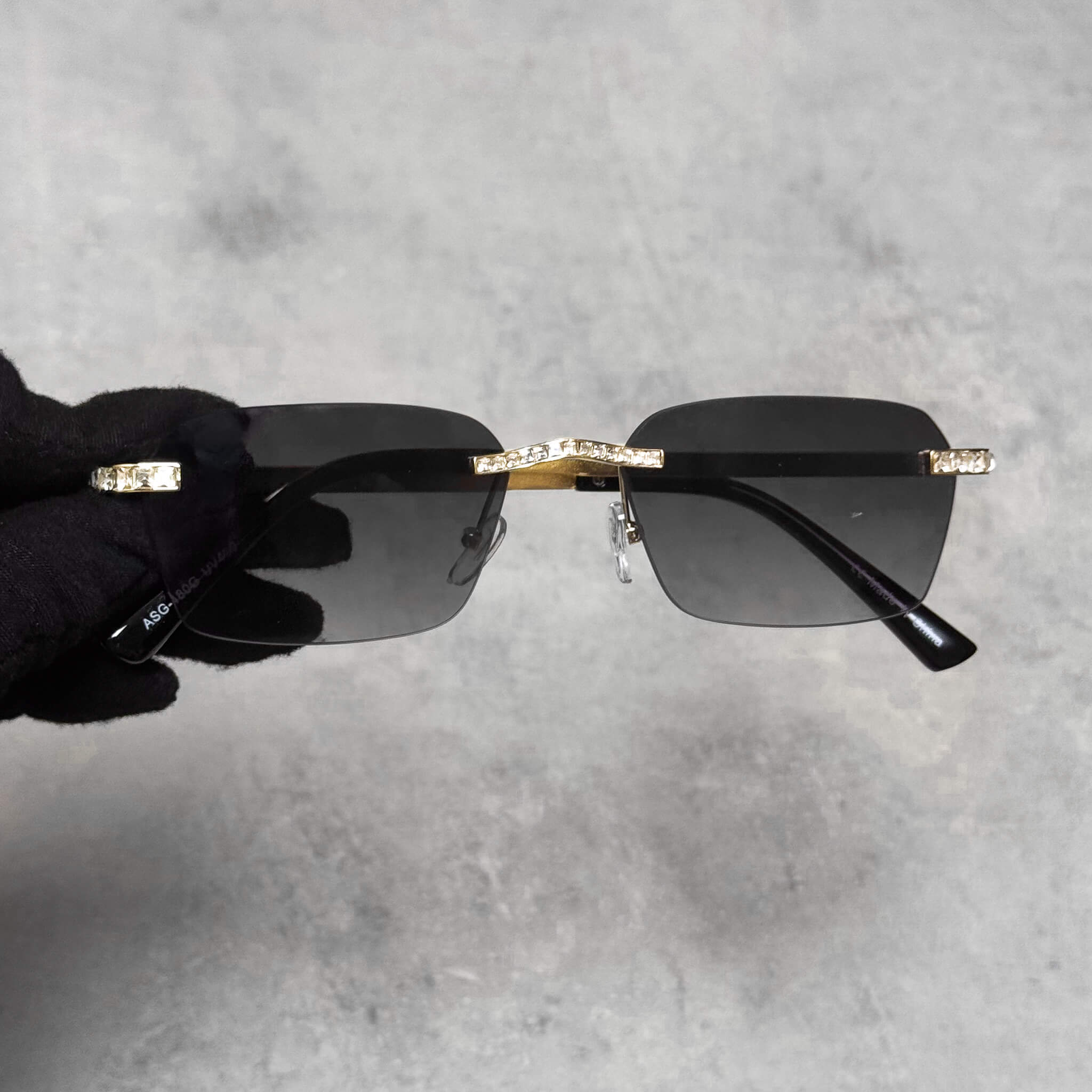 Gold Baguette Stone Sunglasses with smoke lenses and crystal bridge detailing for a luxury finish.