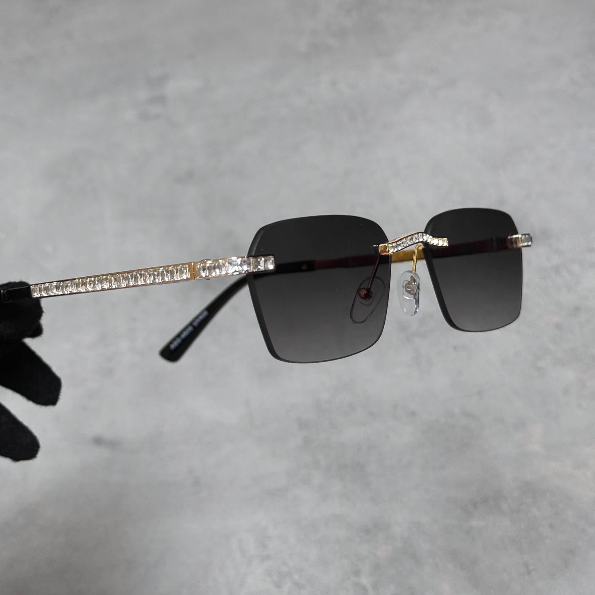 Side view of gold Baguette Stone Sunglasses featuring crystal-set temples and smoke gradient lenses.
