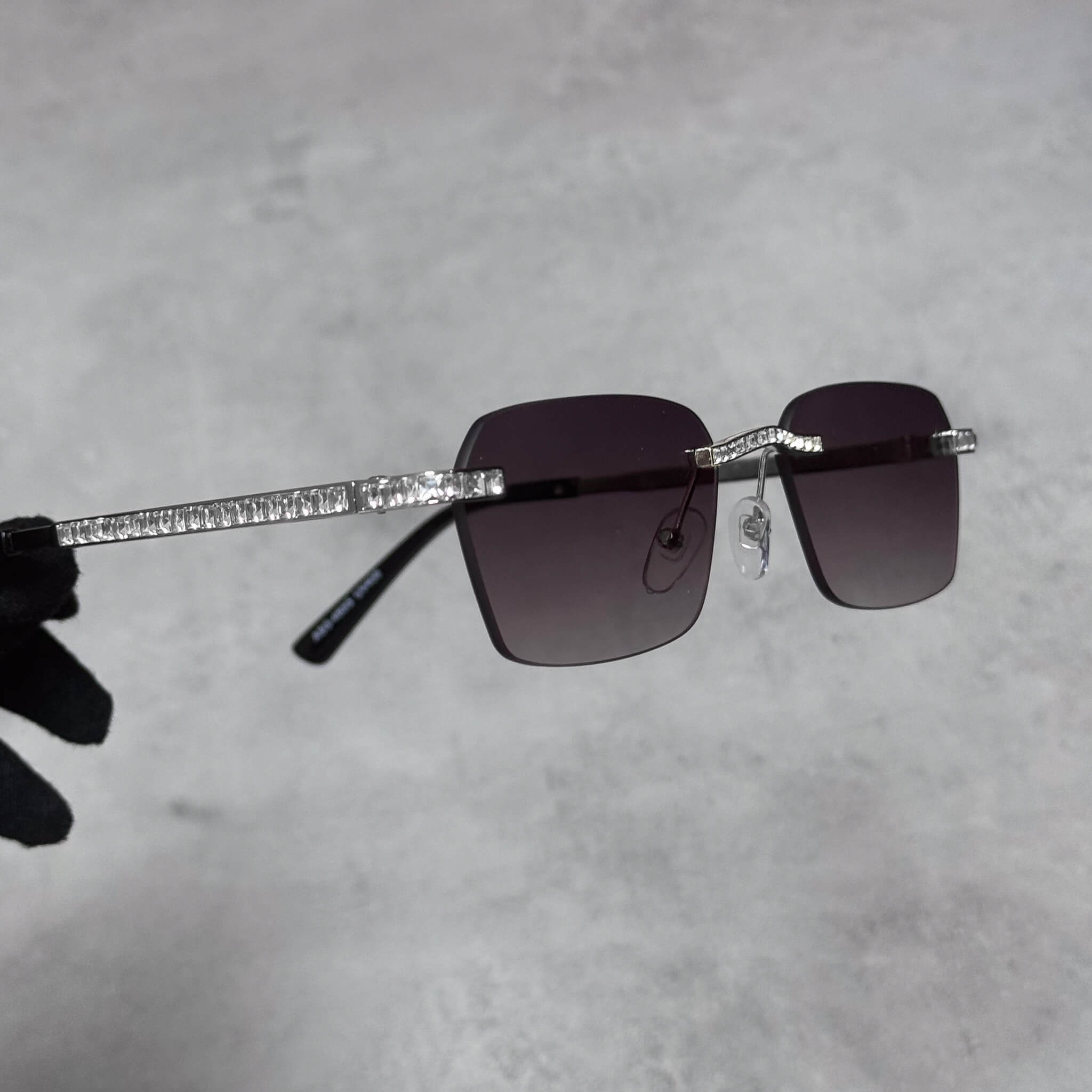 Side view of silver Baguette Stone Sunglasses with baguette crystal temples and smoke gradient lenses.
