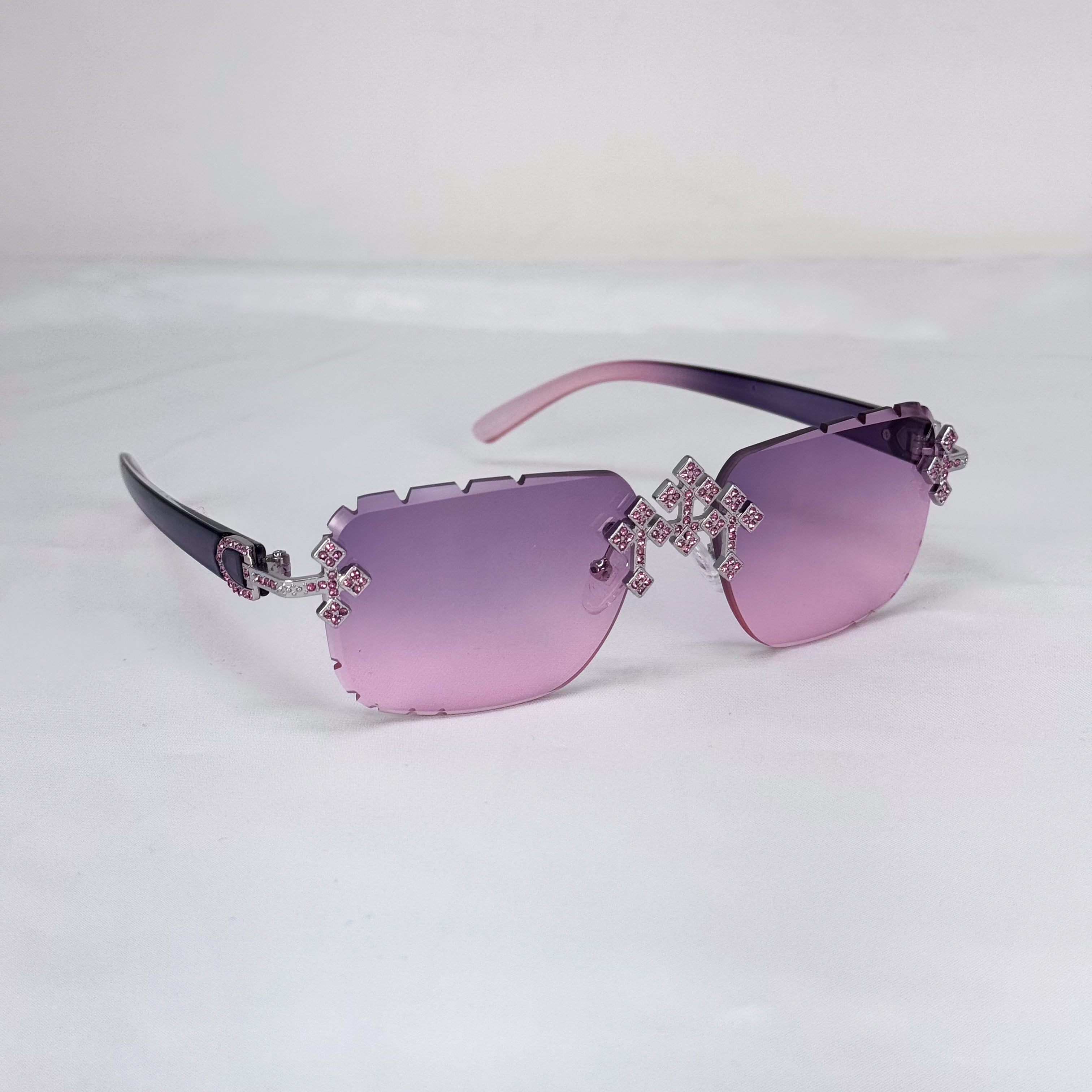 Rimless pink Iced Triple Cross Sunglasses with diamond-cut cross details and purple-pink temple arms.