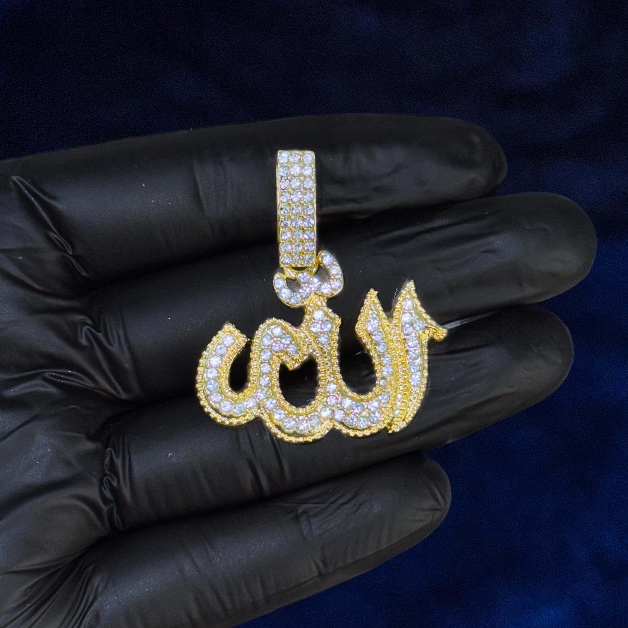 Close-up of gold iced-out 35mm Allah pendant showing detailed stones and gold finish.