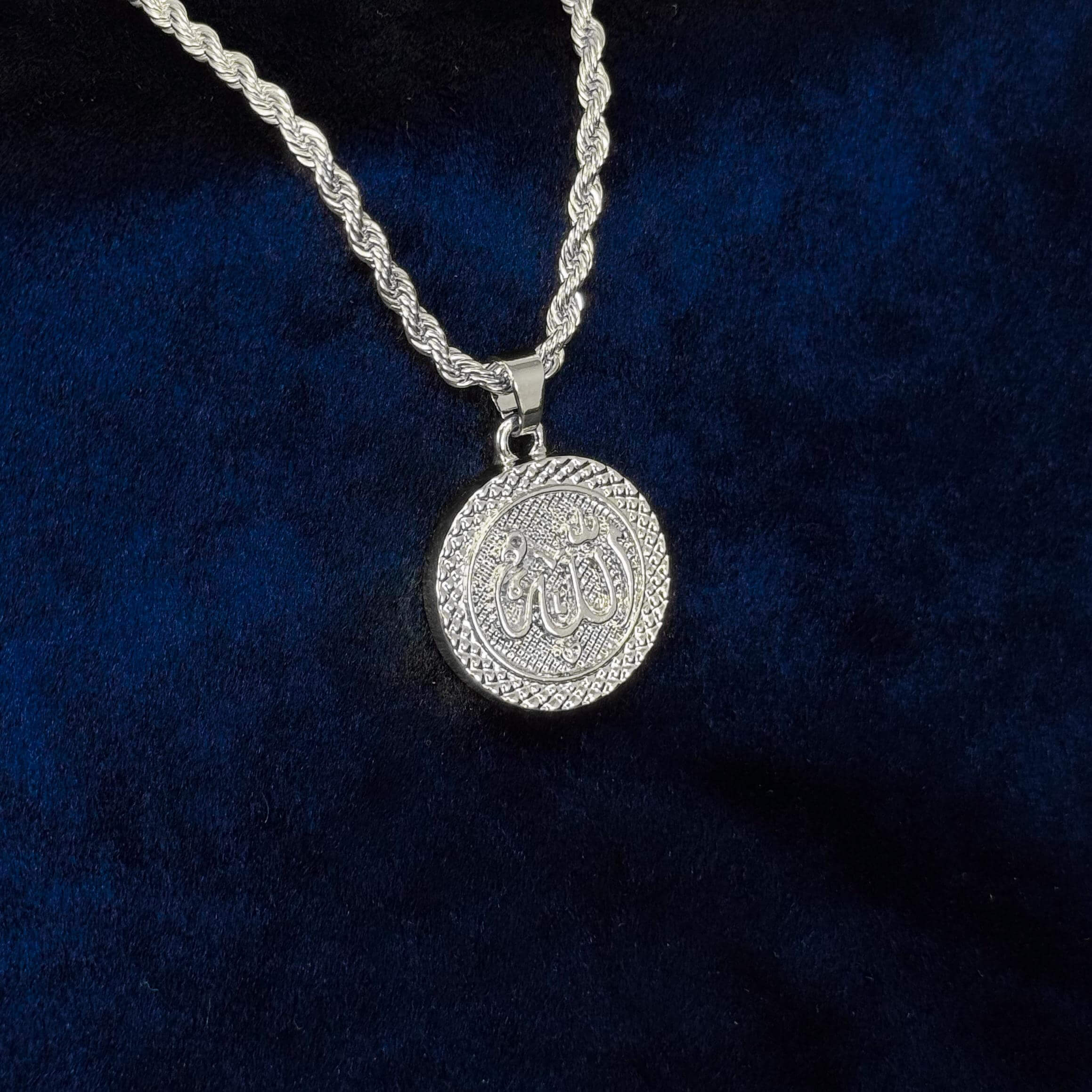 Silver 30mm Iced-Out Allah Medallion Pendant with braided border on rope chain close-up.