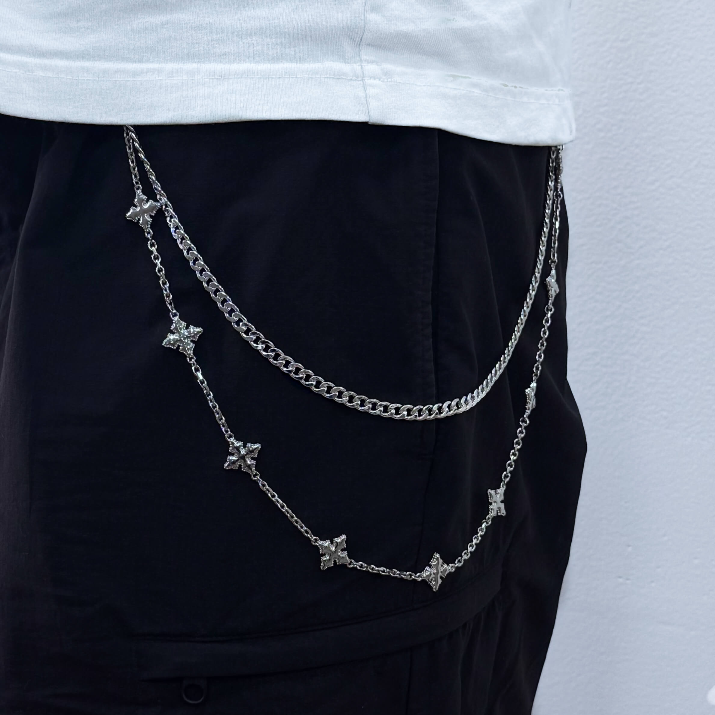 Silver Cuban with Cross Pant Chain styled on black pants, showing layered star details.