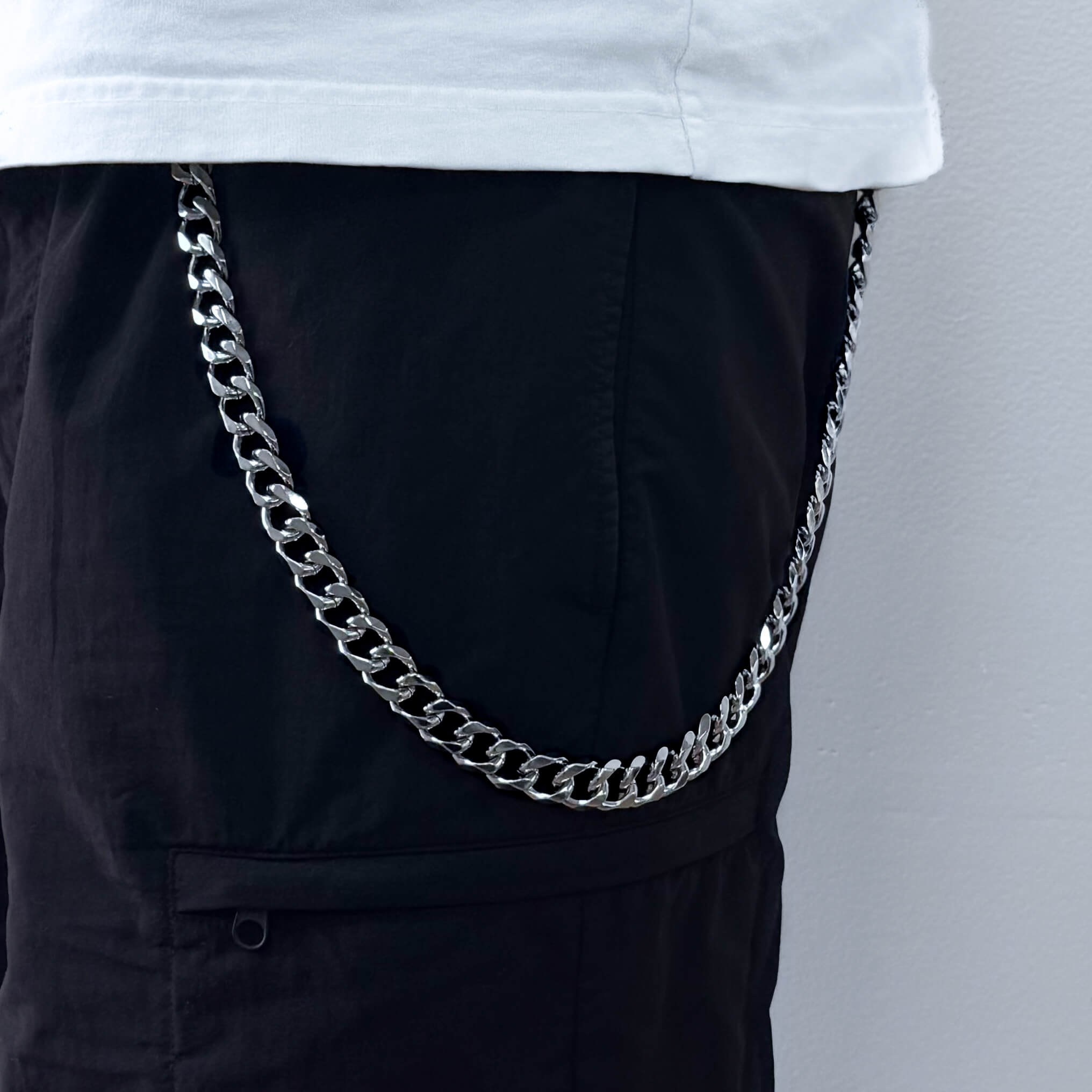 Silver Solid 14mm Cuban Link Pant Chain styled on black pants for streetwear fashion look.