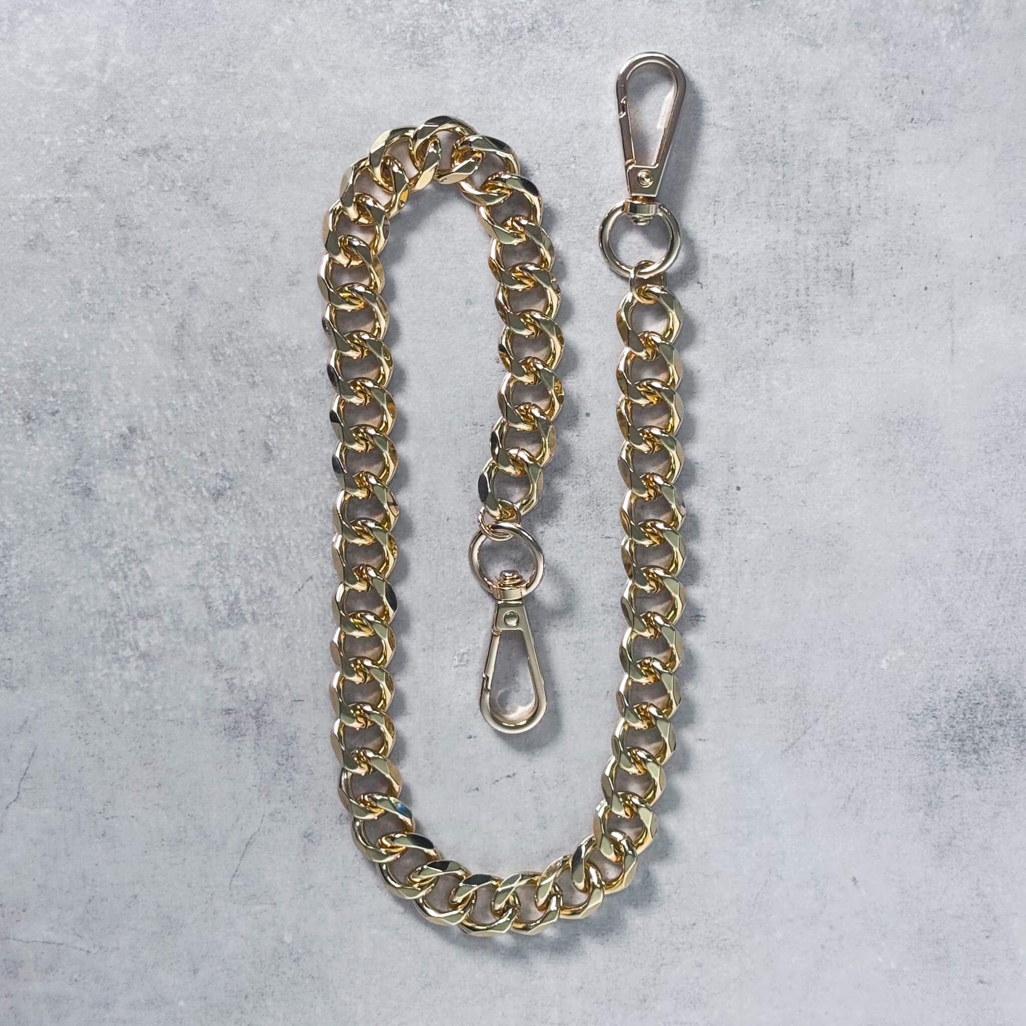 Gold Solid 14mm Cuban Link Pant Chain laid flat showing heavy links and durable clasps.