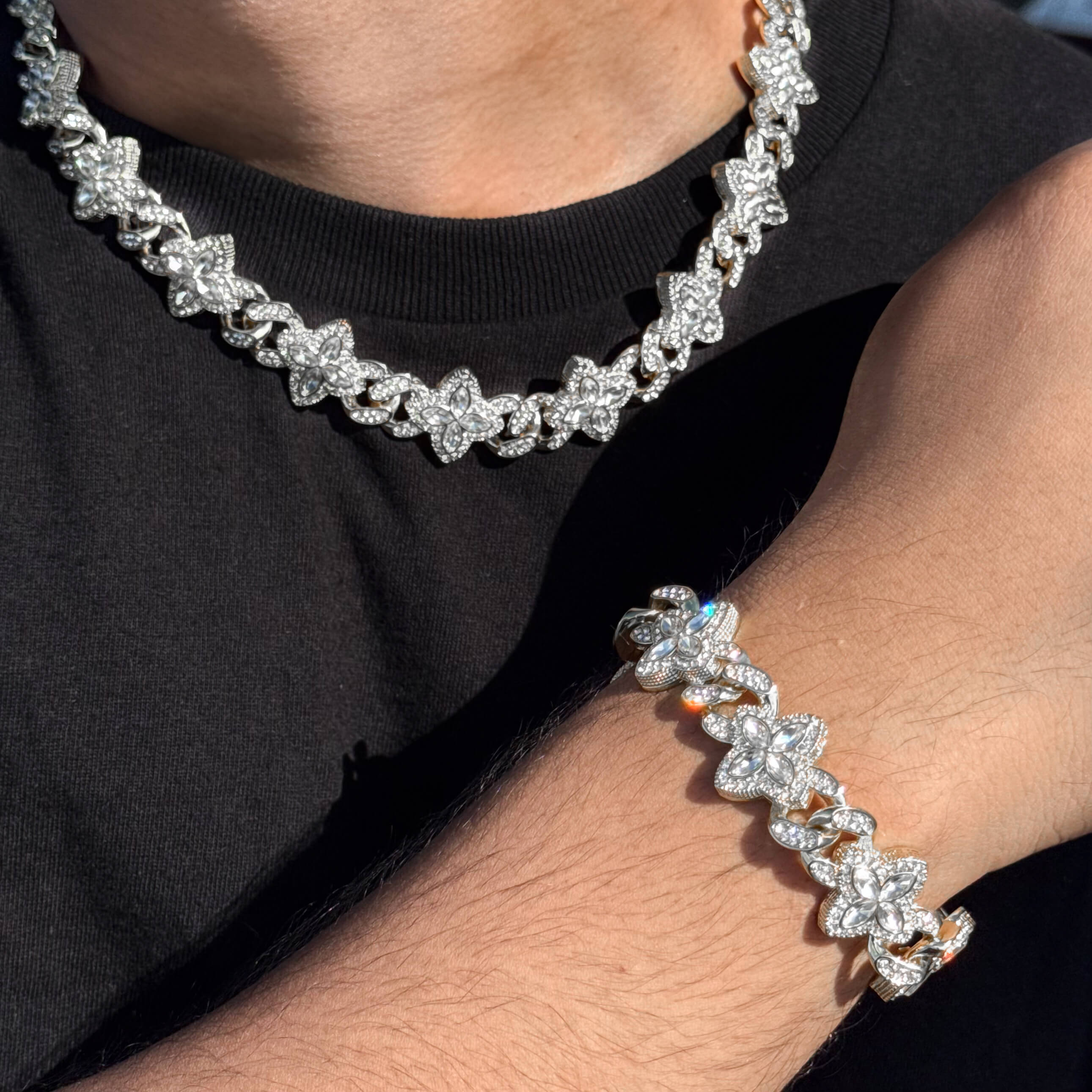 Silver 2-piece iced clover necklace and bracelet set with sparkling clear stones and clover links.