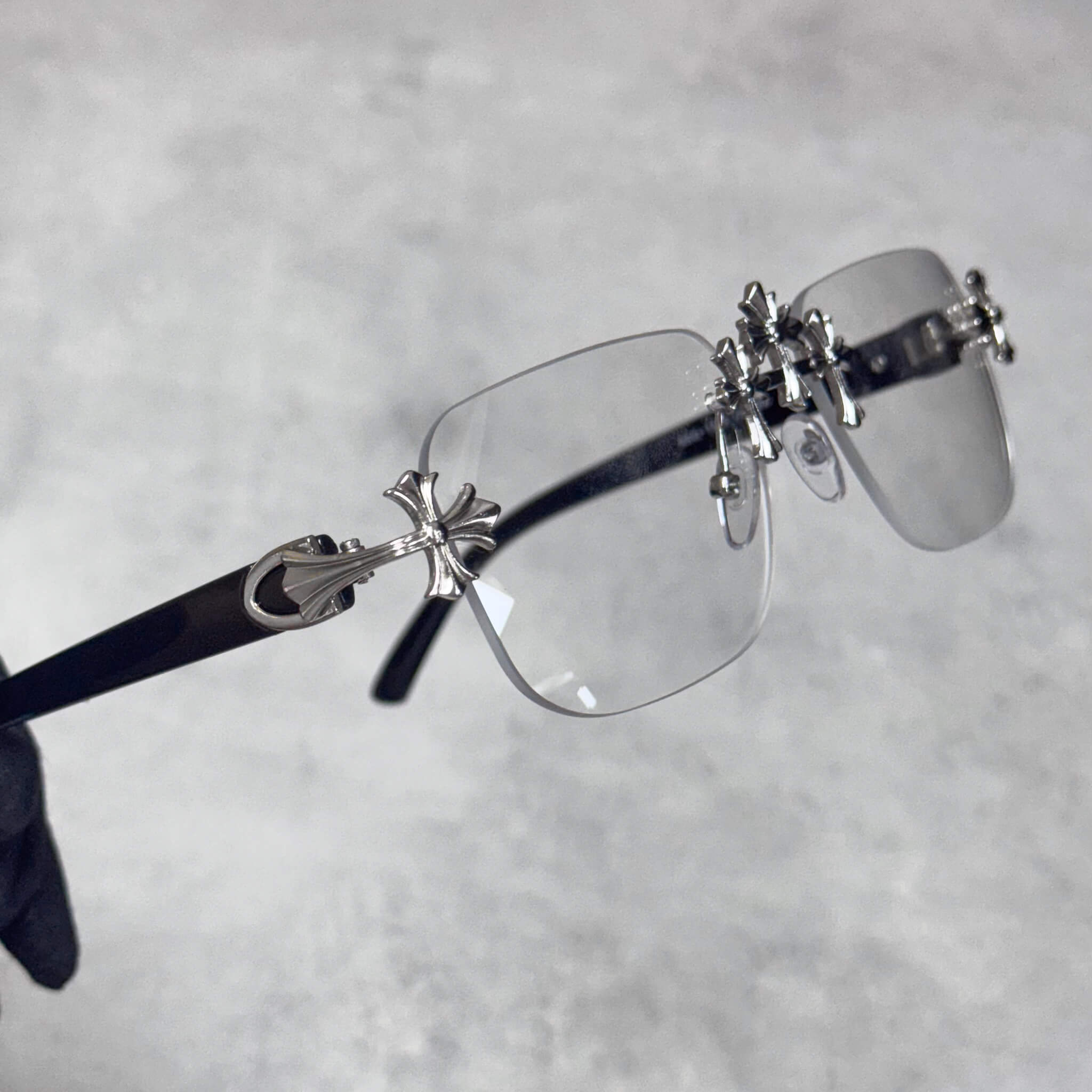 Clear-lens Solid Triple Cross Sunglasses showcasing silver cross side detailing and black arms.