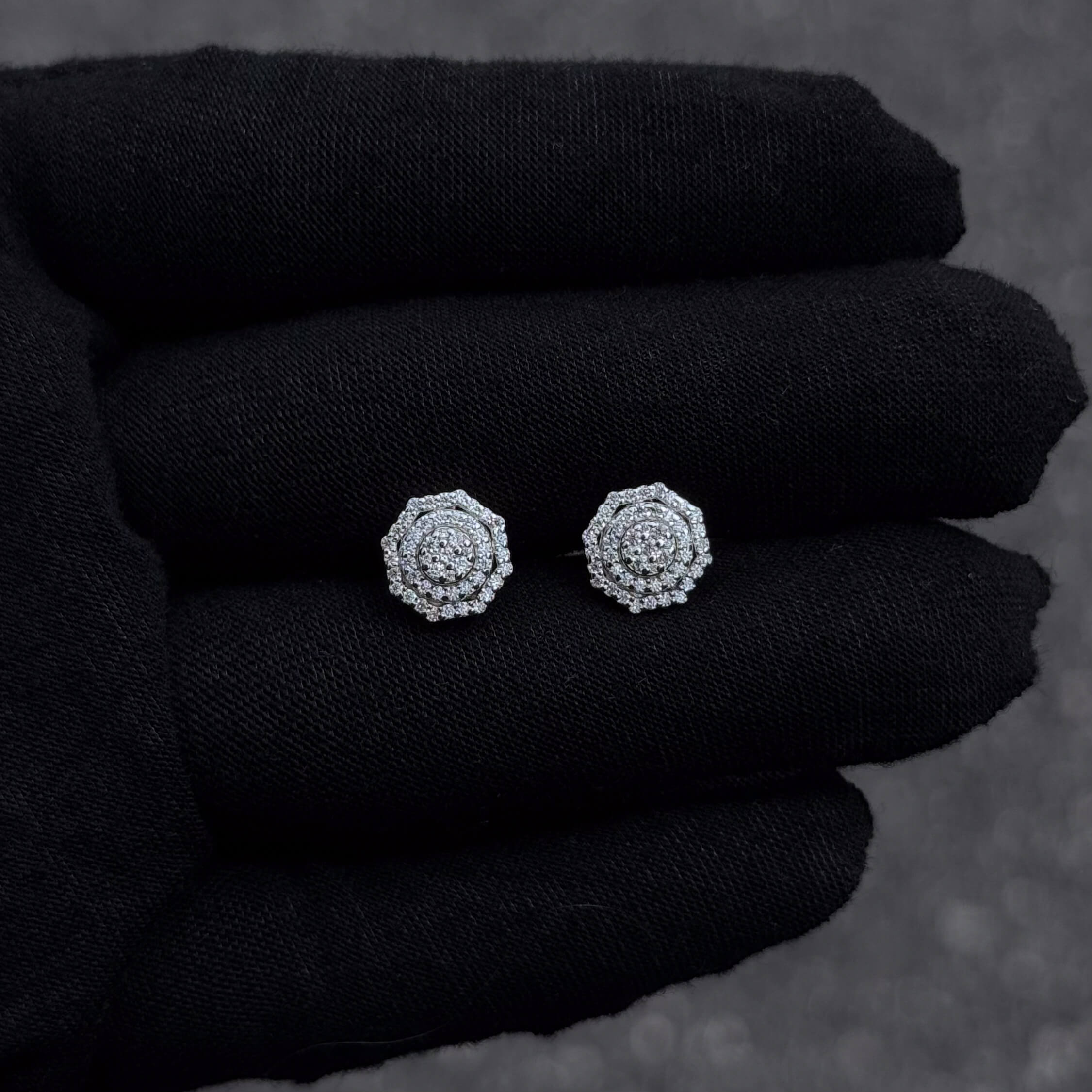 Small 10mm sterling silver octagon moissanite cluster diamond studs shown on black glove.