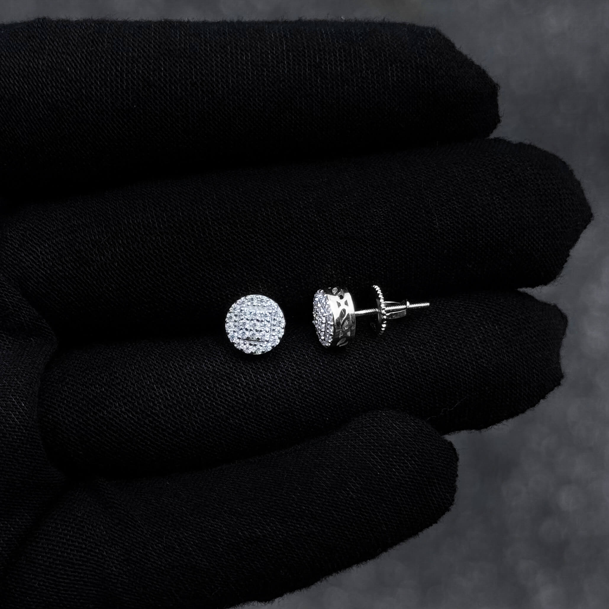 7mm sterling silver moissanite cluster earrings with screw-back posts shown on black glove.