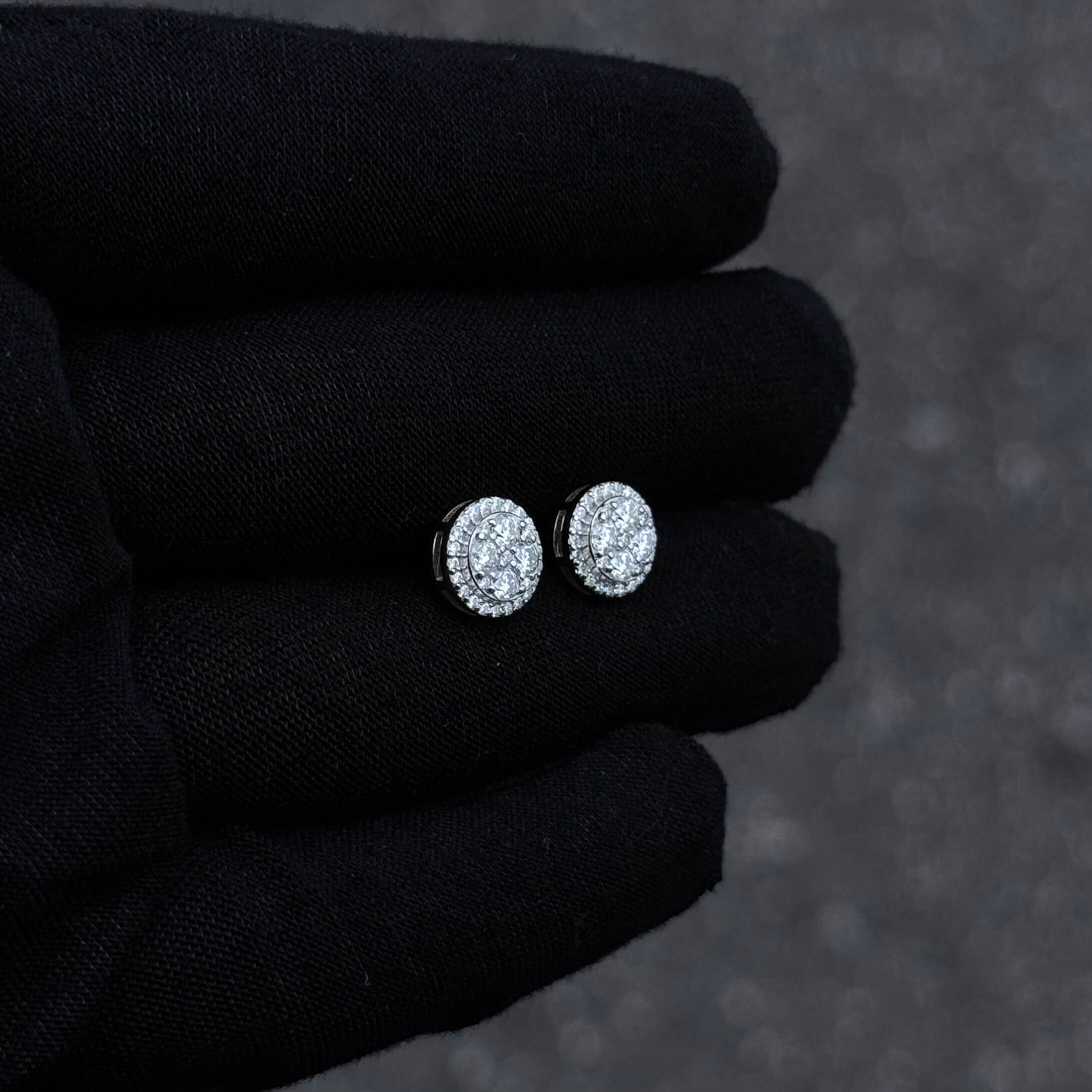 Close-up of 9mm sterling silver round moissanite cluster earrings with layered halo sparkle.