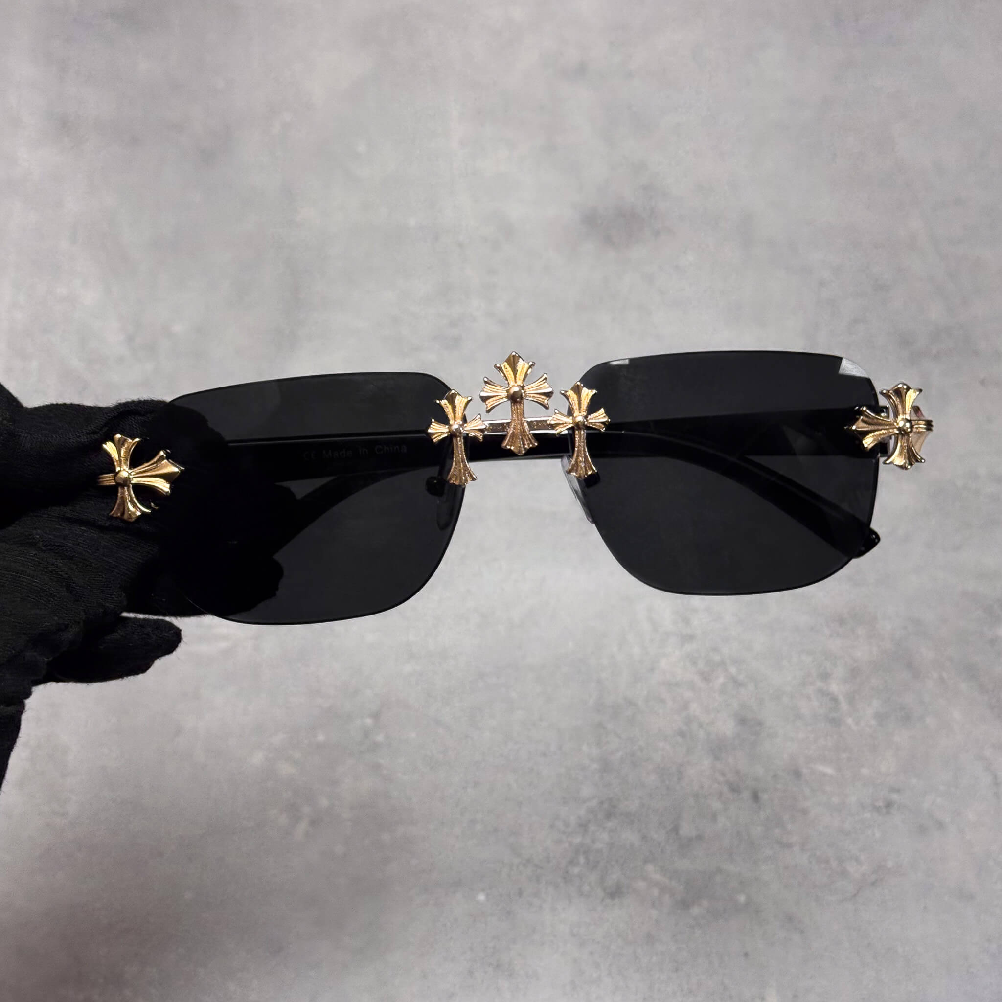 Square black lens Triple Cross Sunglasses with gold cross detailing across the bridge and sides.
