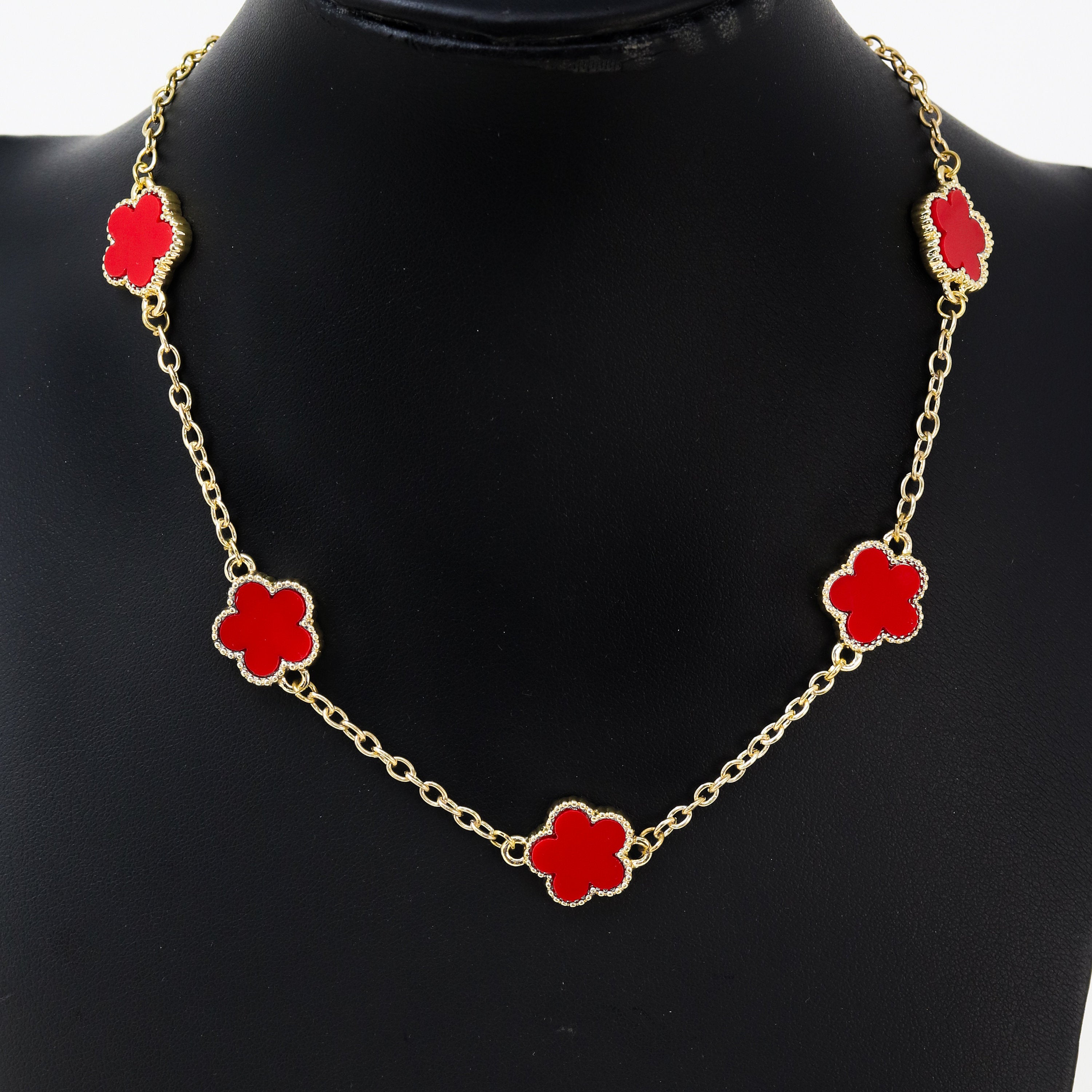 Men's 15mm 5-Leaf Clover Link Chain Necklace in gold finish with bright red enamel clover charms on display bust.