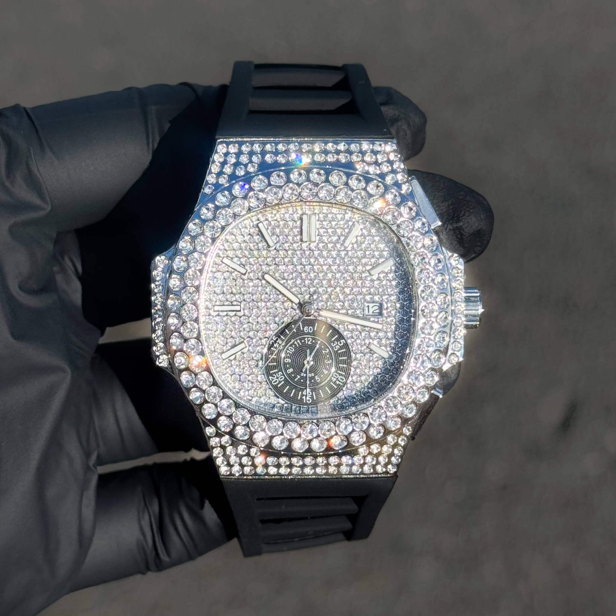 Men's 43mm silver iced out oblong bezel watch with silicone band and fully paved diamond dial.