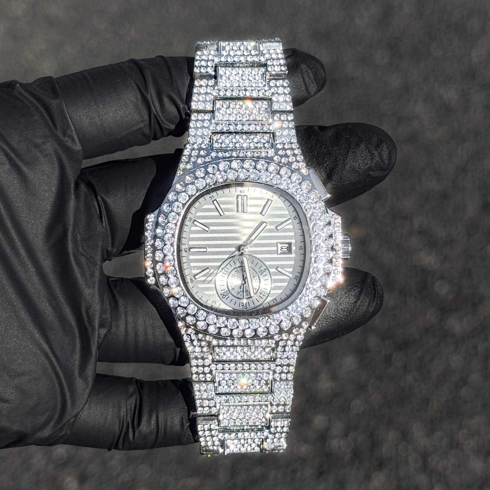 Men's 43mm silver luxury iced out watch featuring quartz movement and full diamond detailing.
