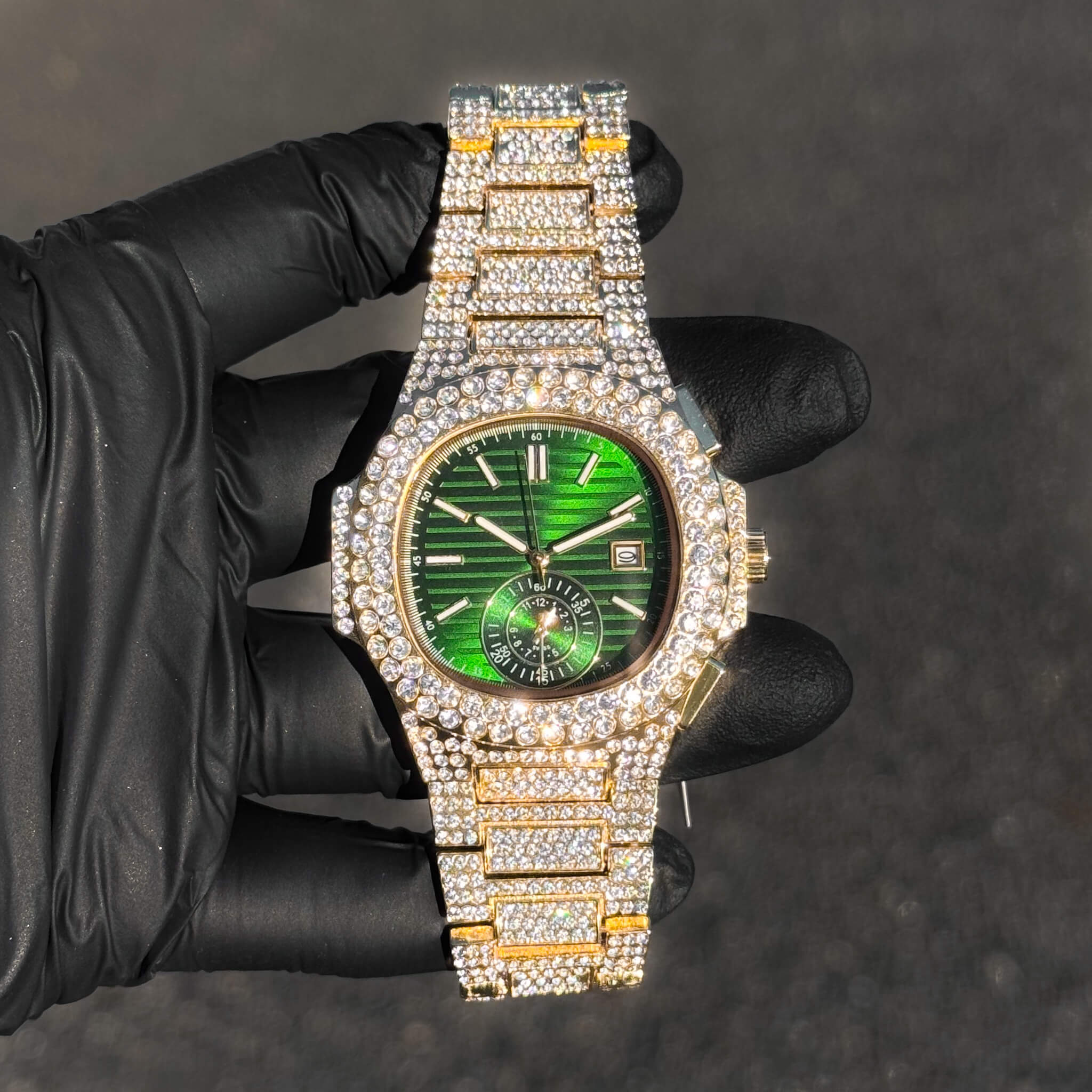 Men's 43mm iced out oblong watch with emerald green dial, quartz movement, and diamond bracelet.