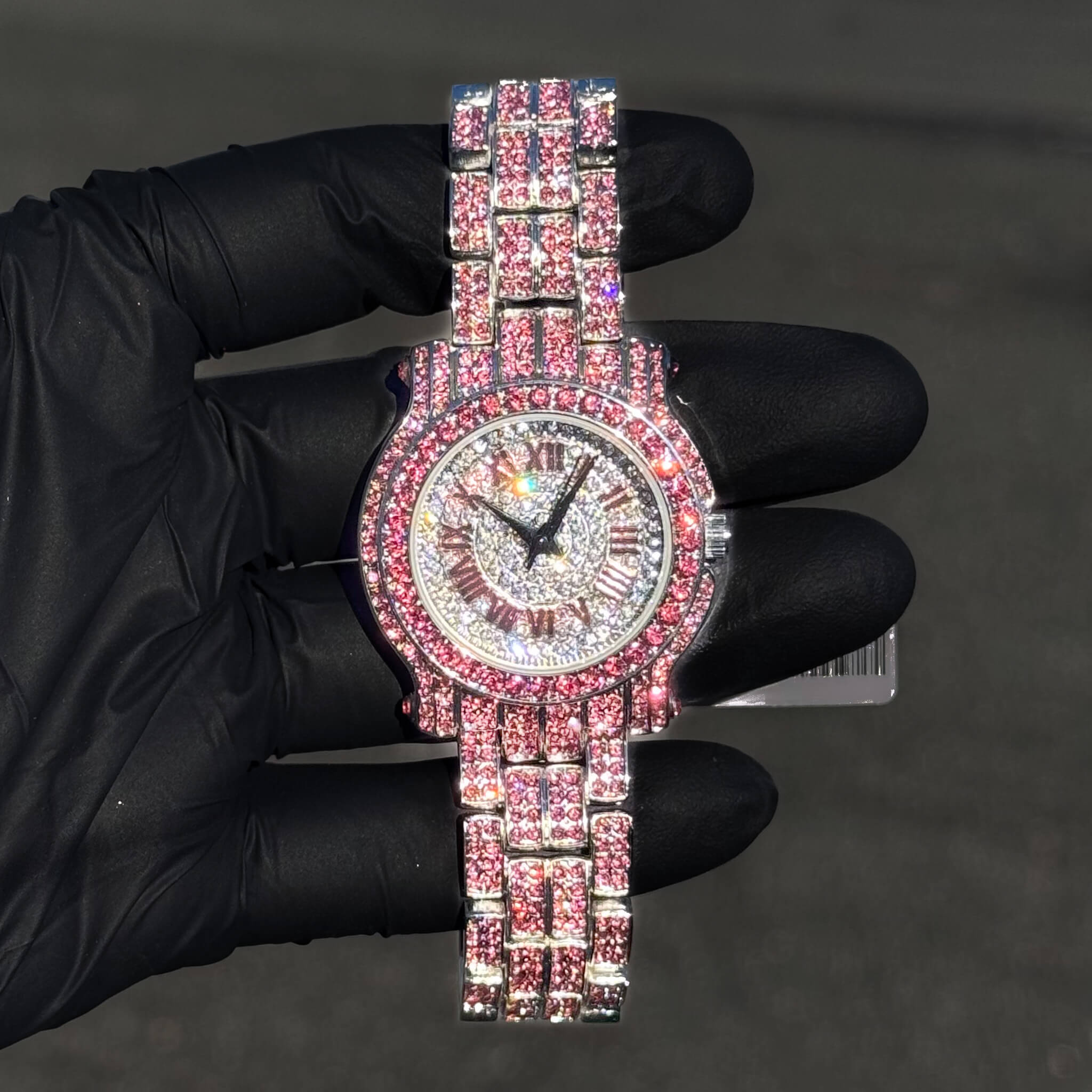 Pink 35mm women’s diamond watch with iced Roman numeral dial and shimmering bracelet links.