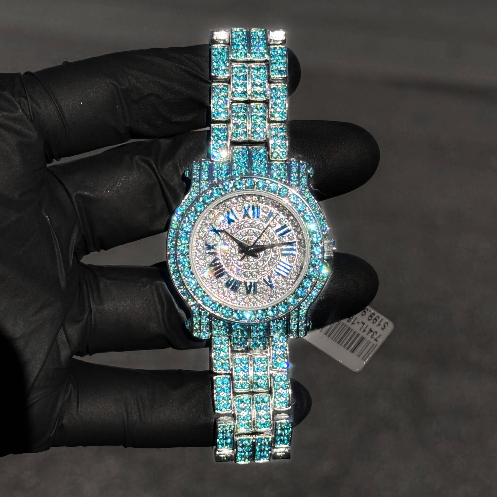 Blue 35mm women’s iced diamond watch showcasing Roman numeral dial and quartz movement.