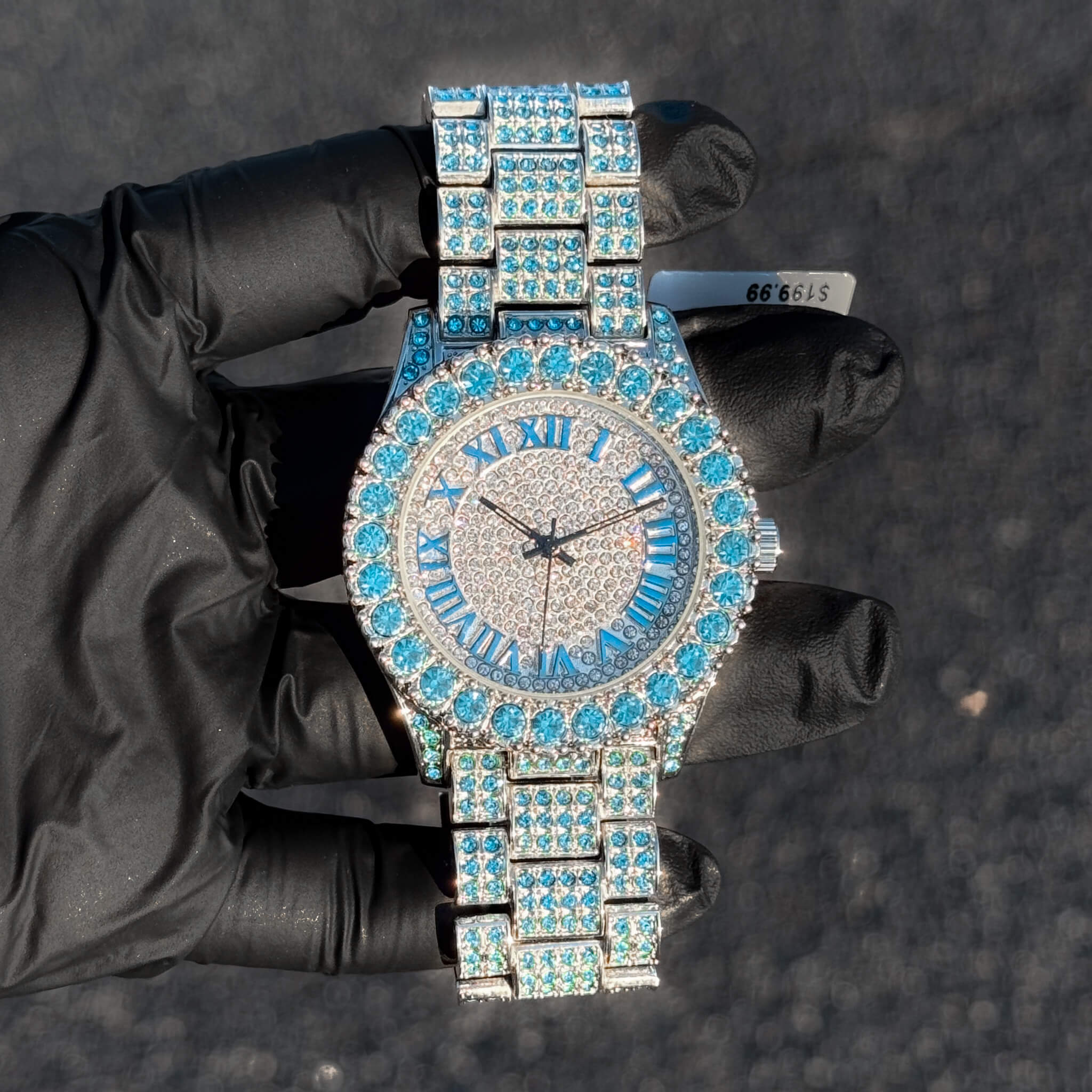 Blue 44mm women’s diamond watch with bold iced Roman round dial and fully stone-set bracelet.