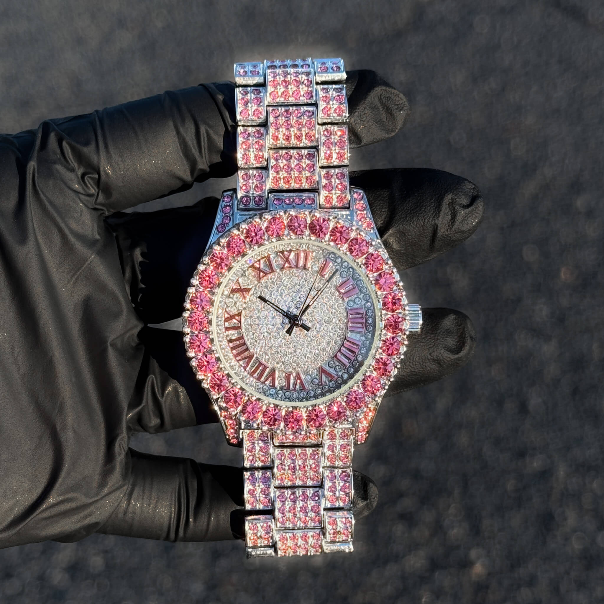 Pink 44mm women’s vibrant diamond watch with iced Roman round dial and shimmering bracelet links.