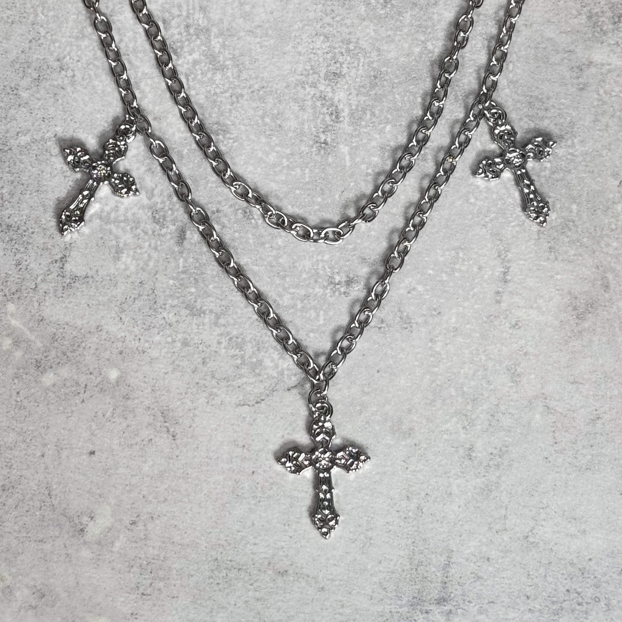 Hanging Cross Pant Chain featuring layered silver chains with detailed cross pendants.
