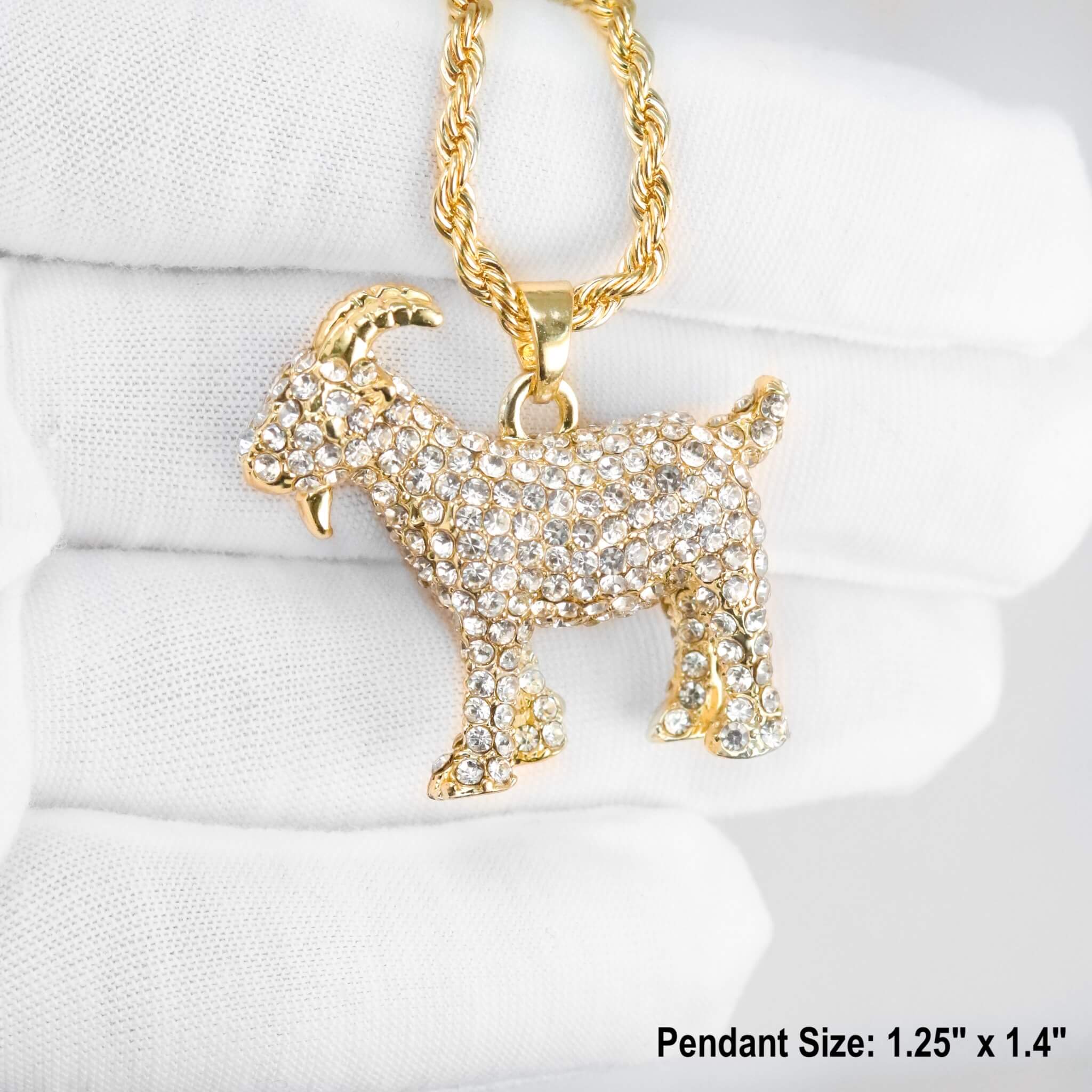 Close-up of gold iced out GOAT pendant with handset stones on rope chain, luxury statement piece.