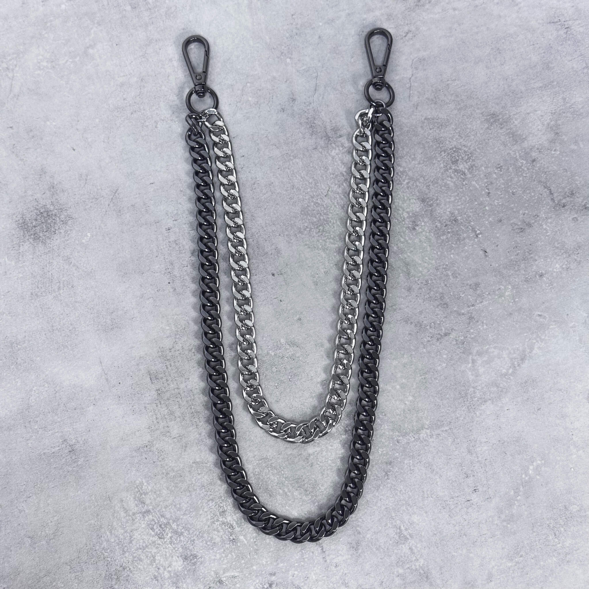 Flat-lay view of two-tone Duo Cuban Chain Link Pant Chain showing layered curb chain design.