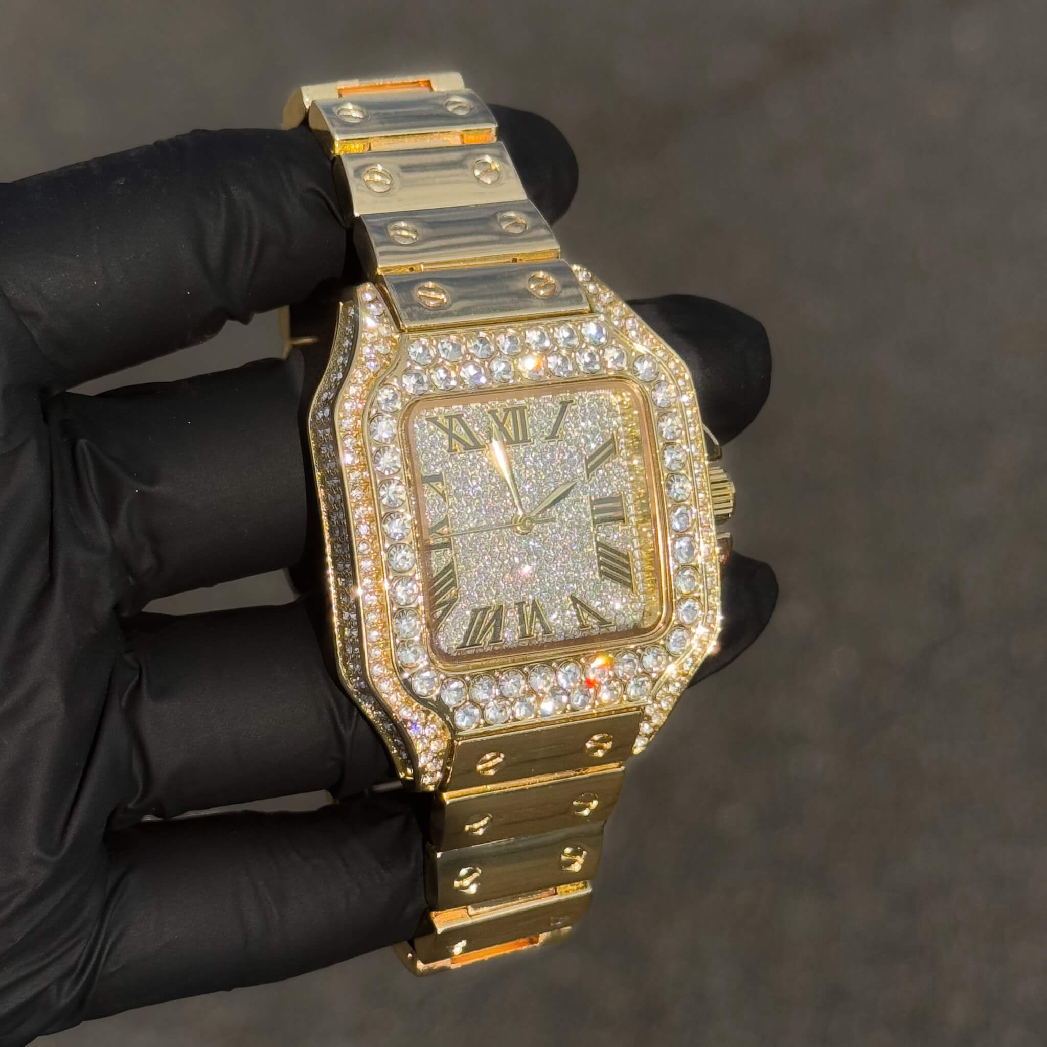 Angled view of gold 40mm iced out square dial men’s watch with shimmering crystal face.