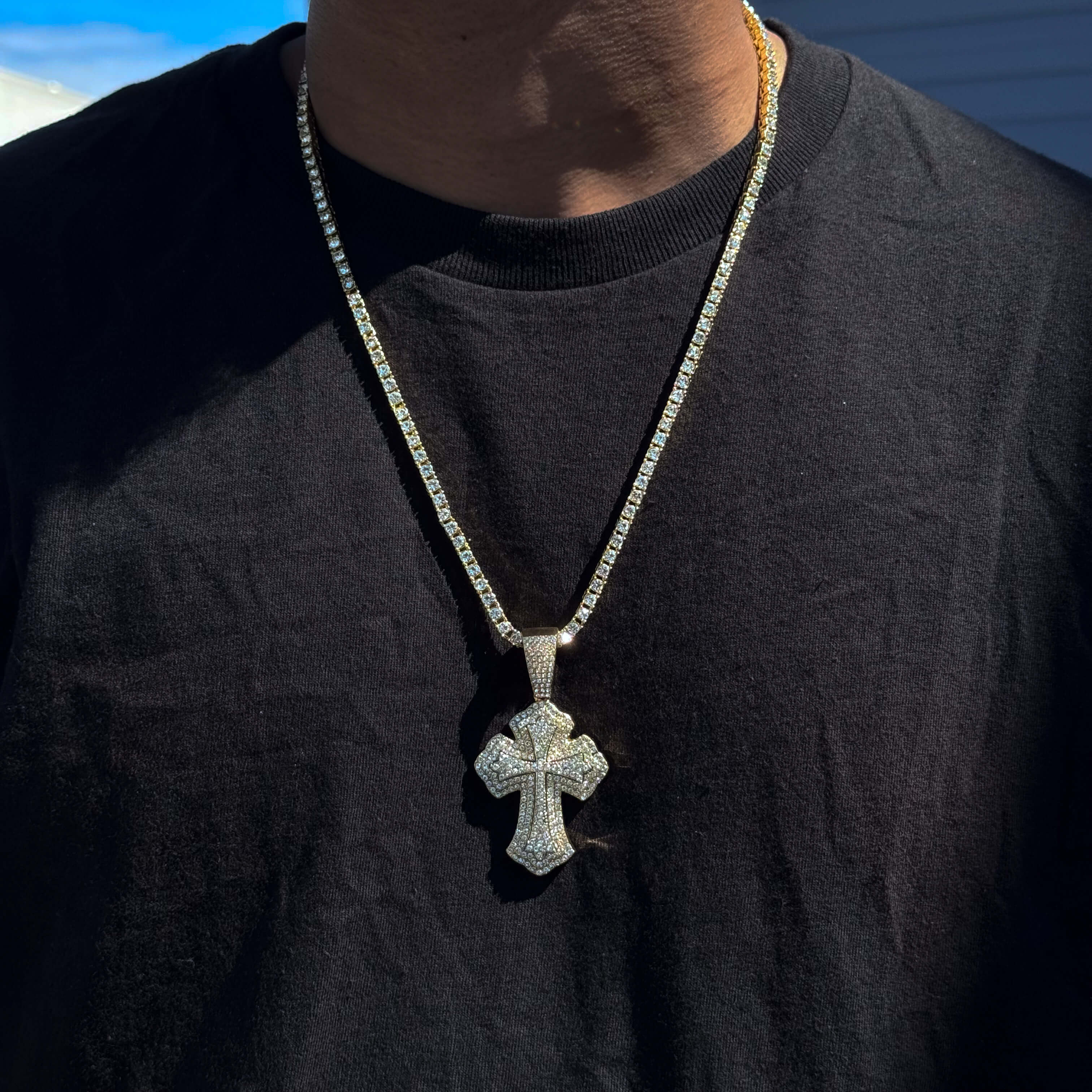 Gold men’s 42mm iced-out cross pendant on 5mm tennis chain featuring sparkling clear stones.
