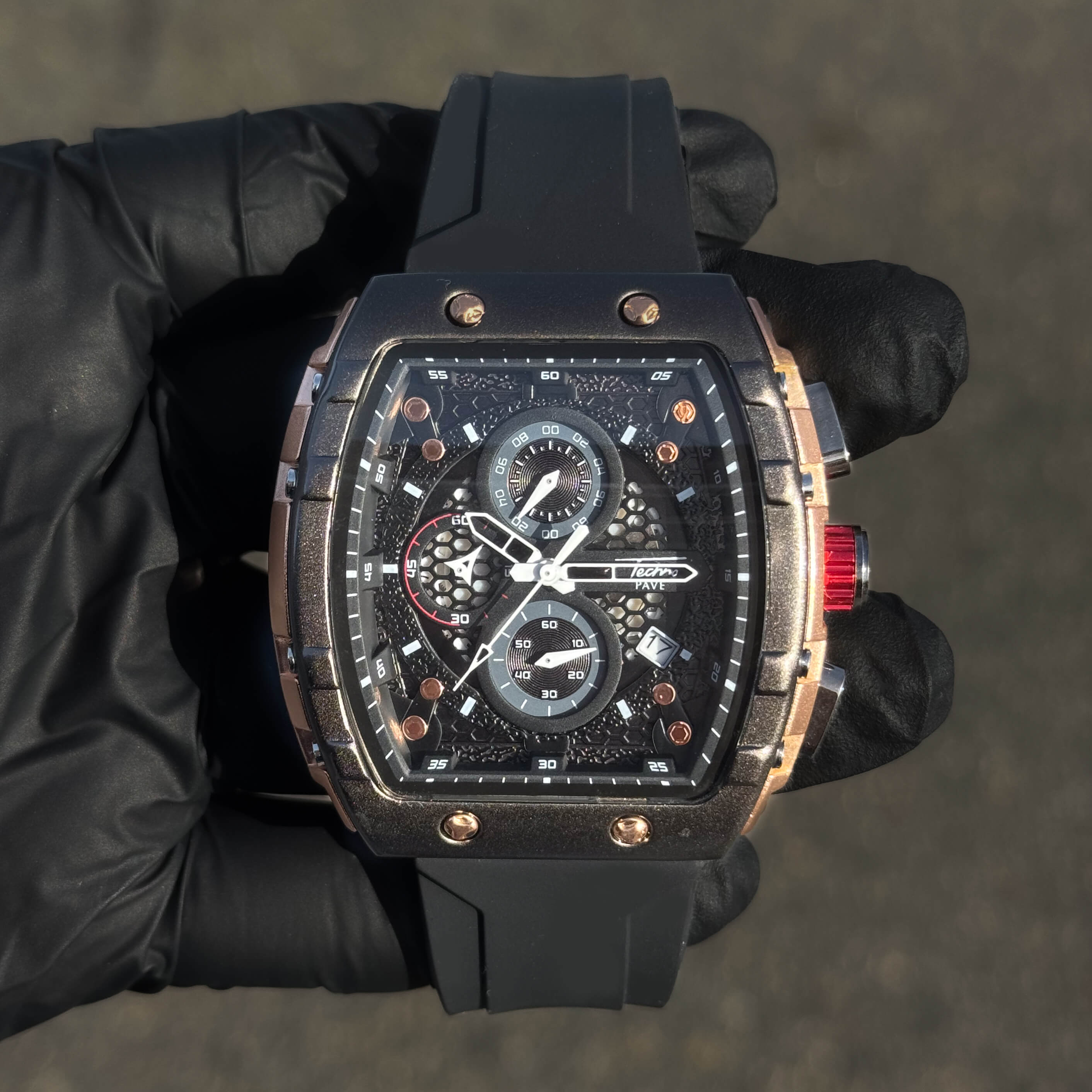 Men's 46mm bold sporty tonneau watch with black silicone band and rose-gold accented dial.