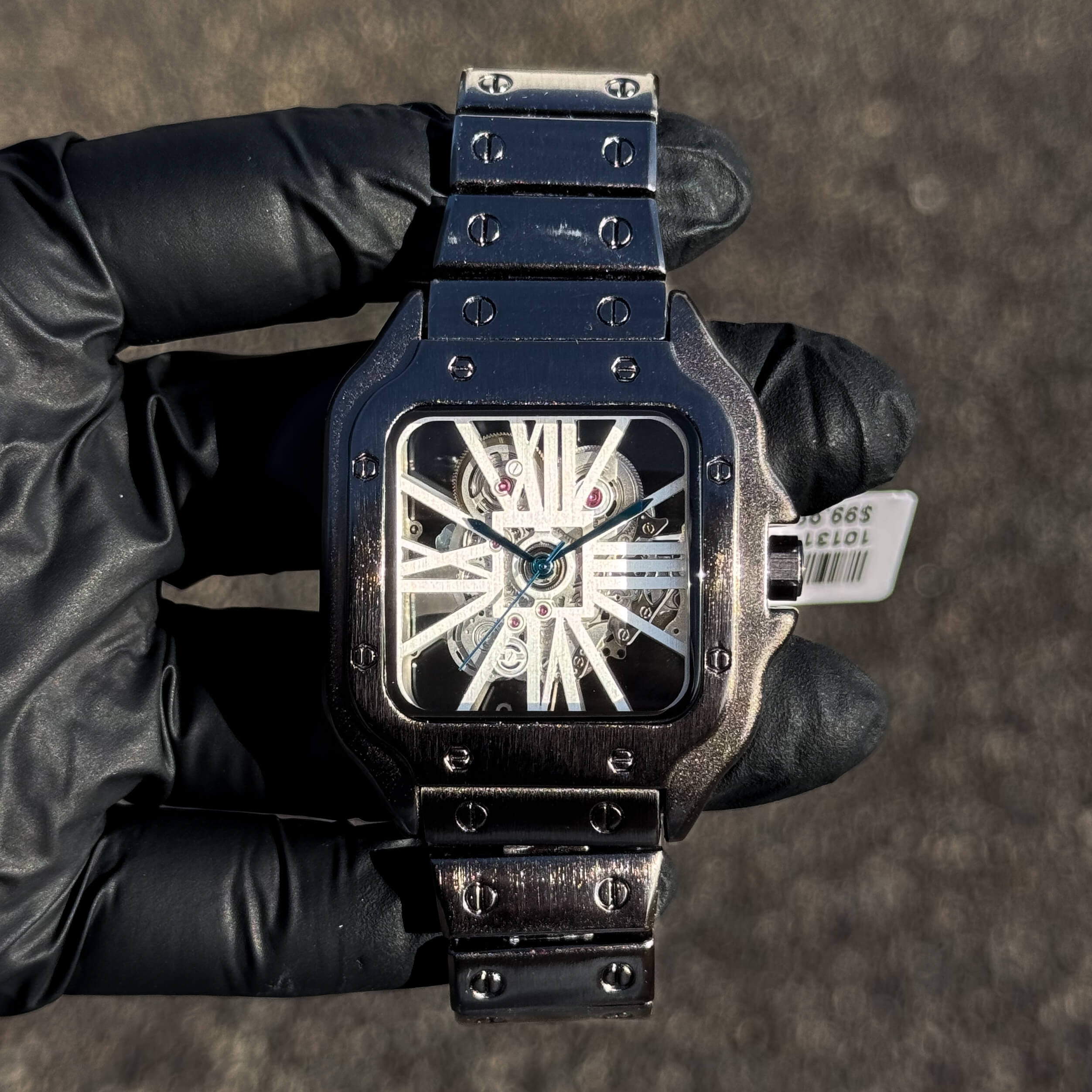 Men's 40mm gunmetal square watch with skeleton dial and industrial gun-finish bracelet.