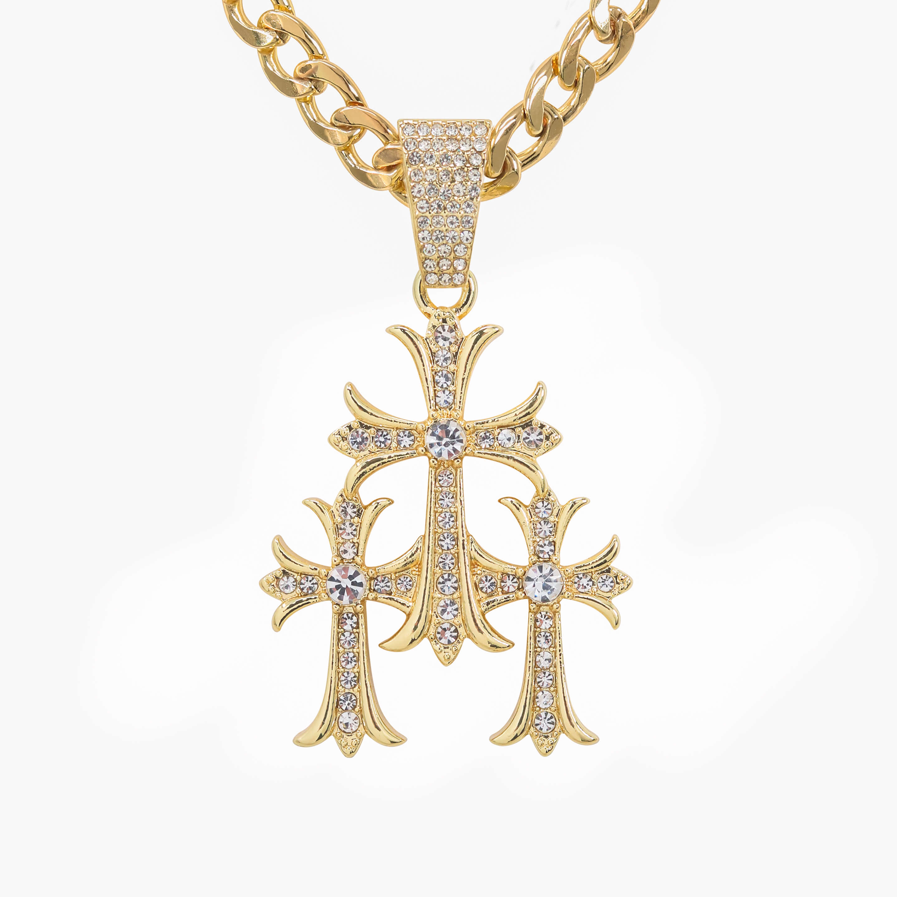 Gold iced out triple cross pendant with crystal stones on Cuban chain, luxury faith jewelry piece.
