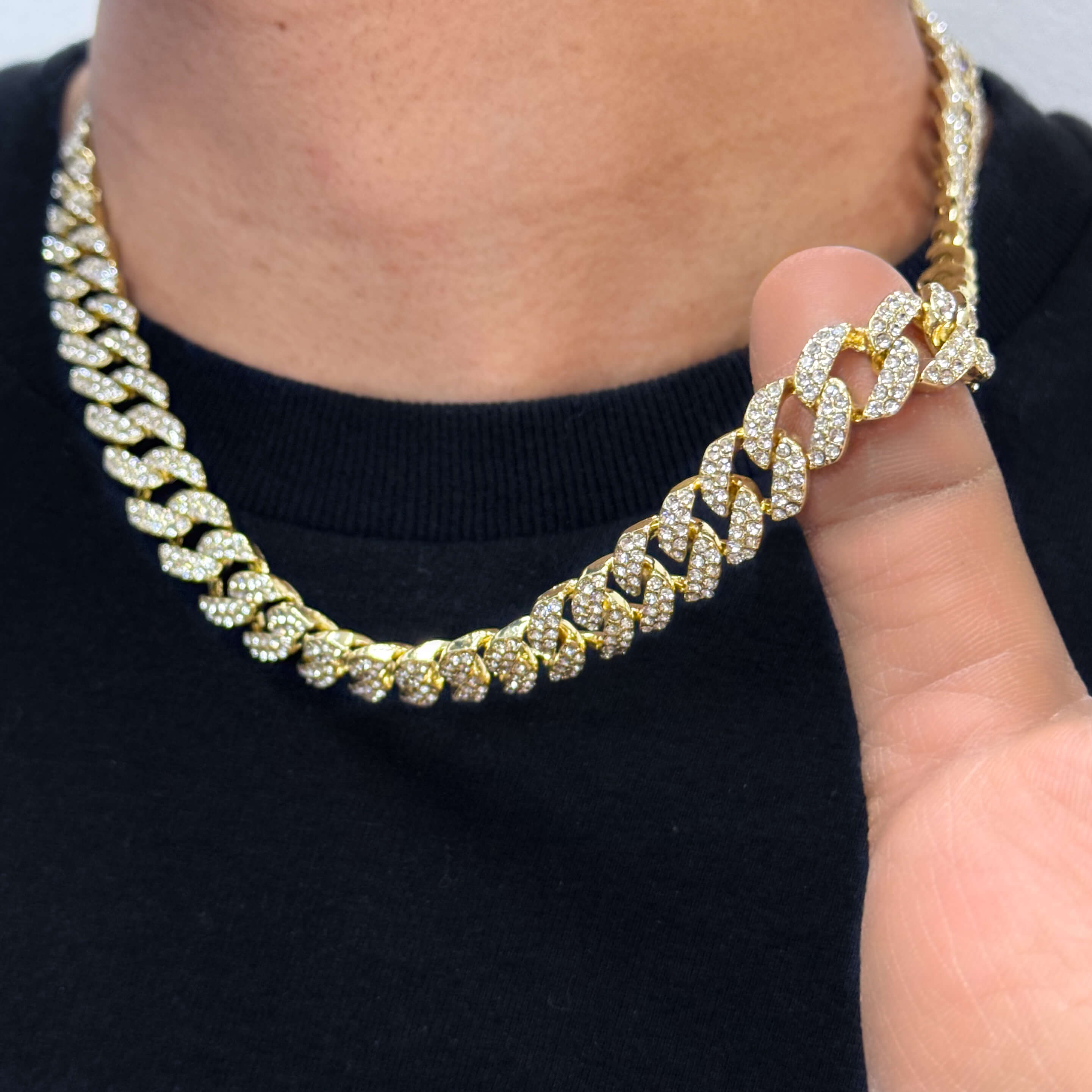 13mm Iced Out Cuban Chain in gold, pavé-set CZ diamond links, close-up worn around neck.