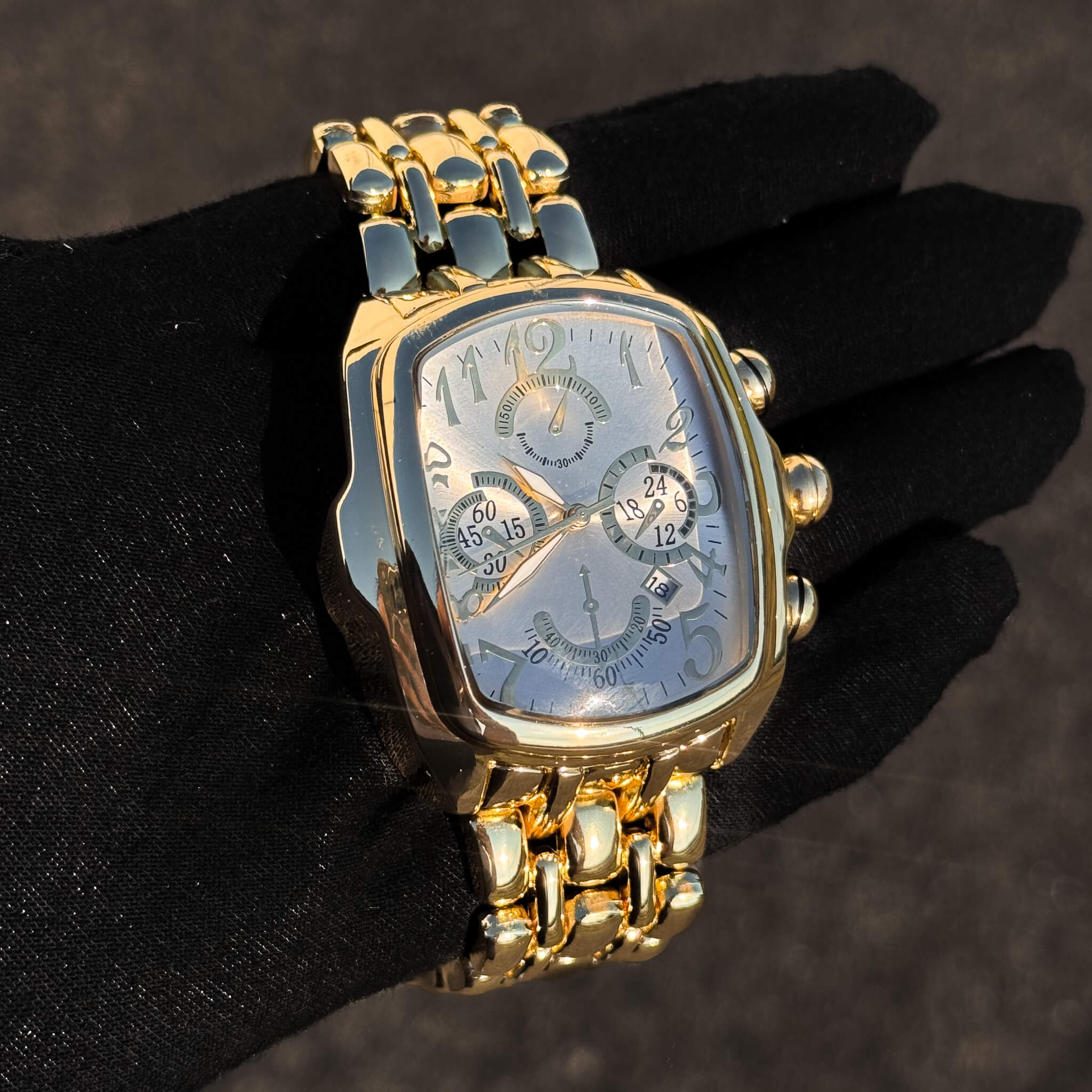 Men’s 43mm gold tonneau watch with silver textured dial and multi-function quartz display.