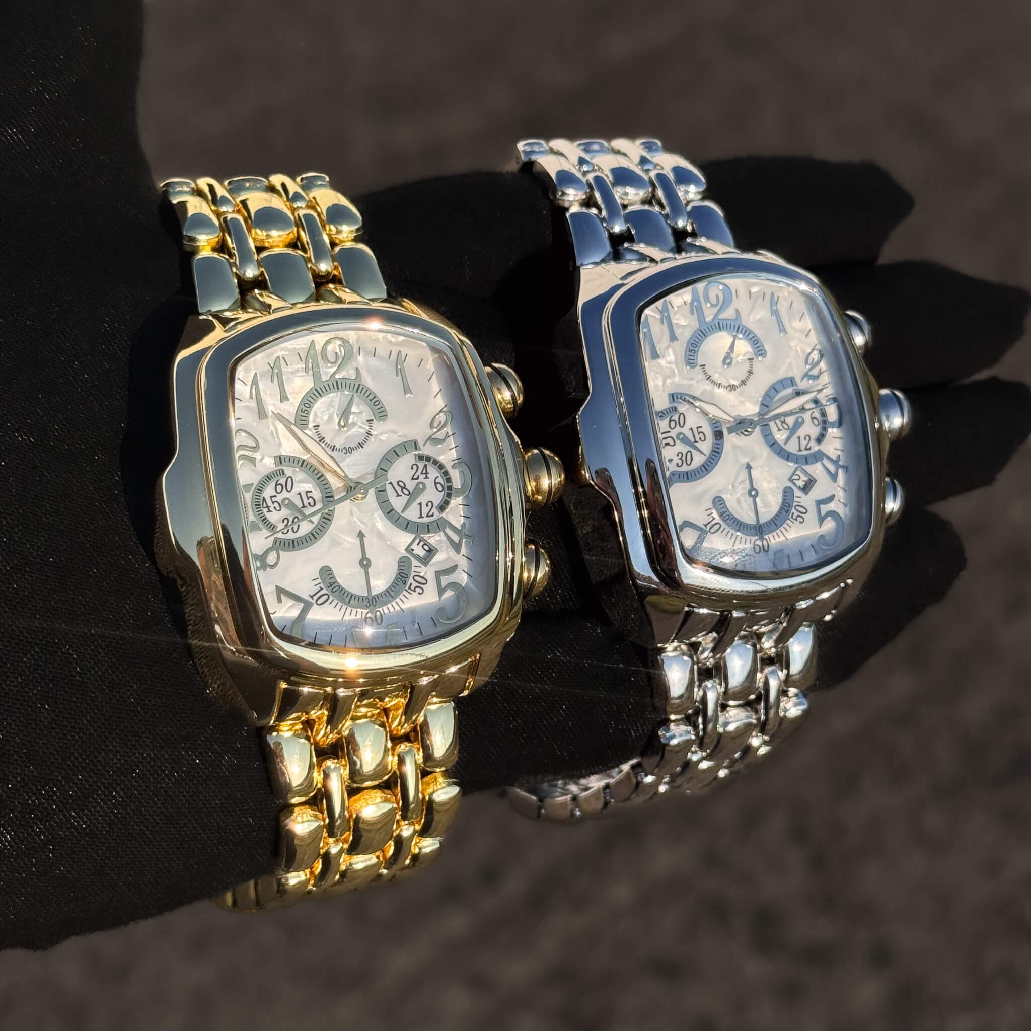 Men’s 43mm tonneau watches in gold and silver with white chronograph dials and metal bands.