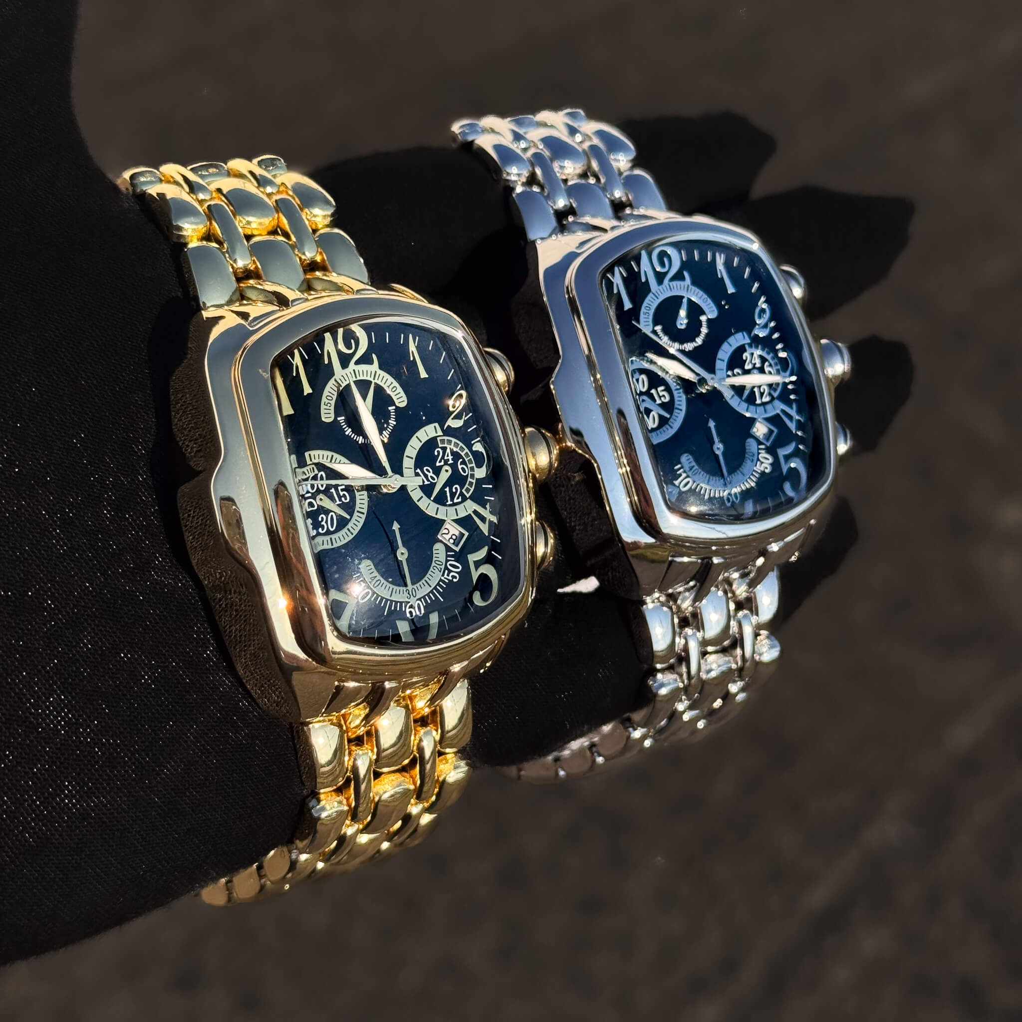 Men’s 43mm gold and silver tonneau watches featuring black chronograph dials and metal bands.