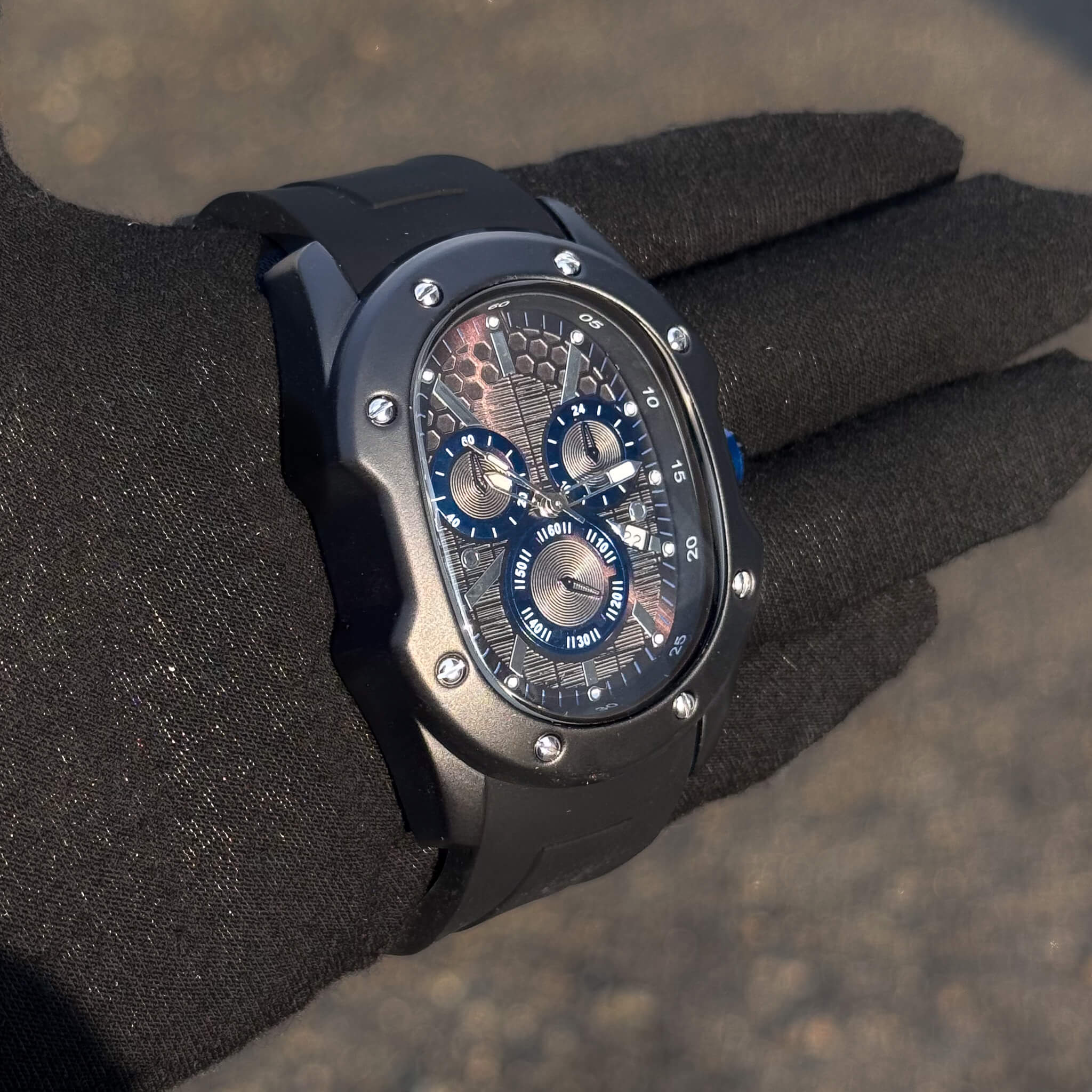 Side view of Men’s 40mm Classic Black Watch featuring blue subdials and textured honeycomb face.