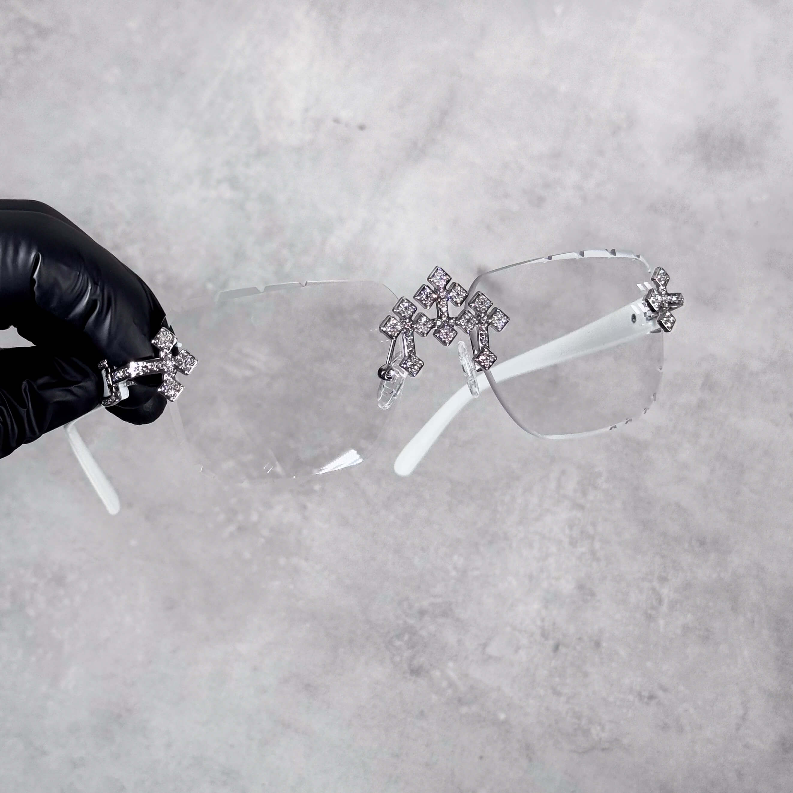 White Iced Triple Cross Sunglasses with clear rimless lenses and sparkling silver cross details.