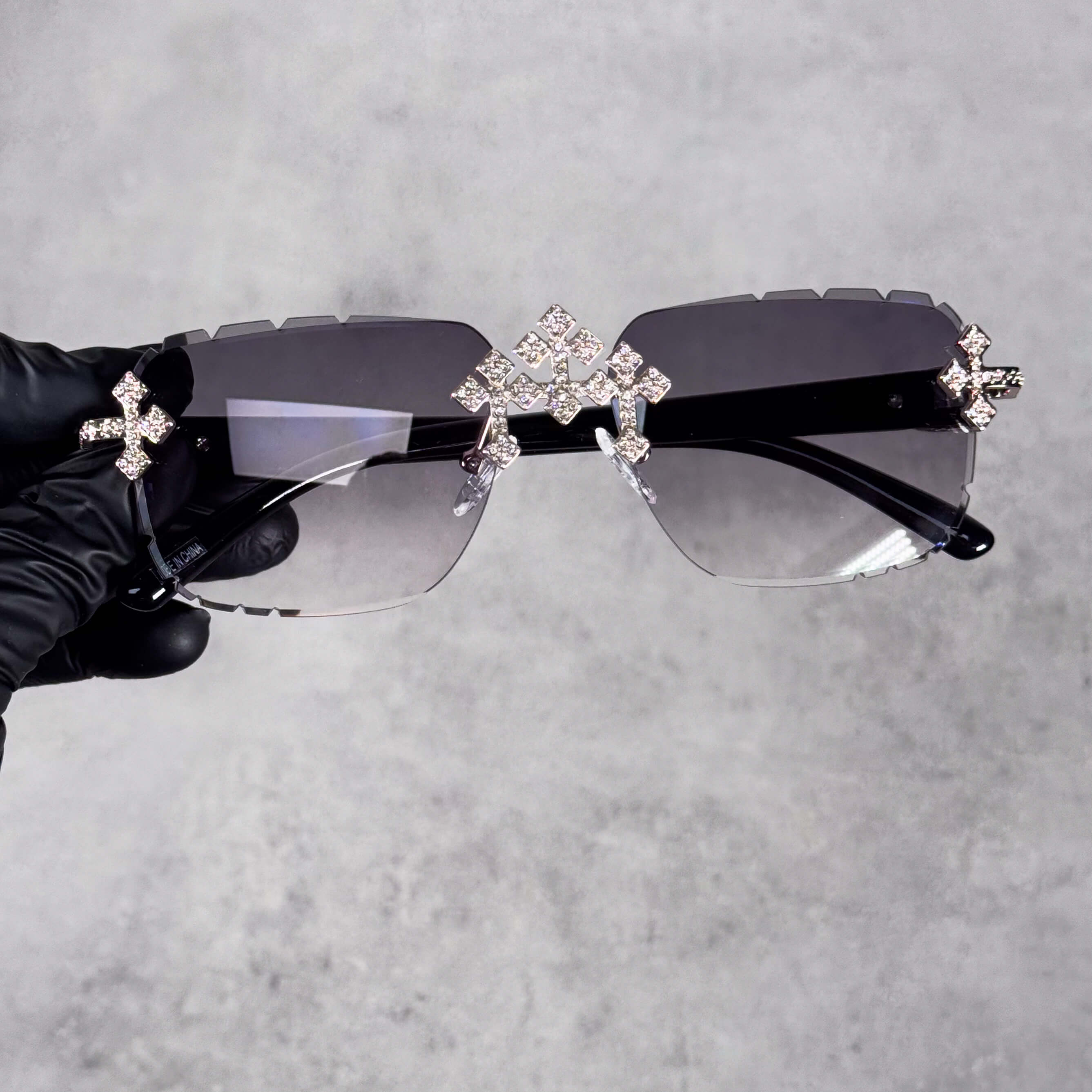 Rimless Iced Triple Cross Sunglasses featuring smoke gradient lenses and sparkling crystal cross details.