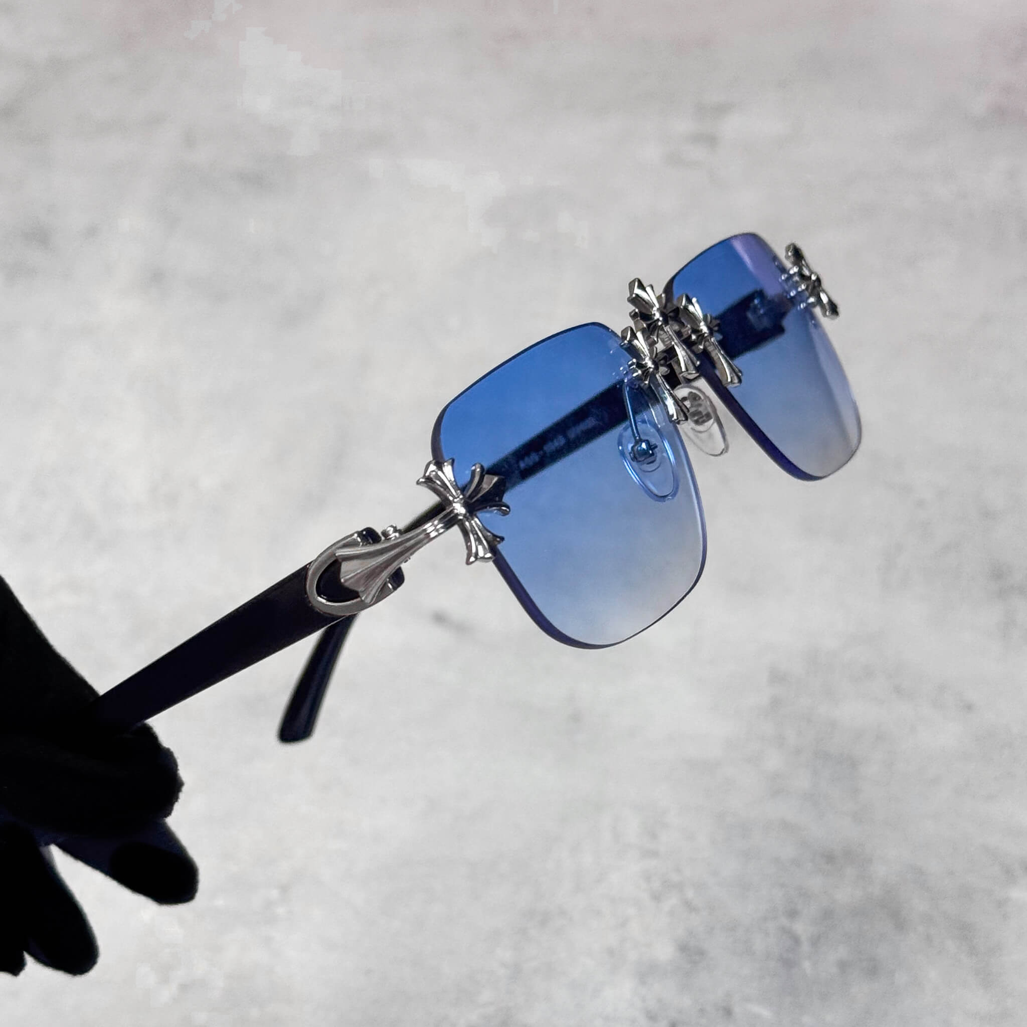 Blue gradient Solid Triple Cross Sunglasses featuring silver cross detailing and rimless frame.